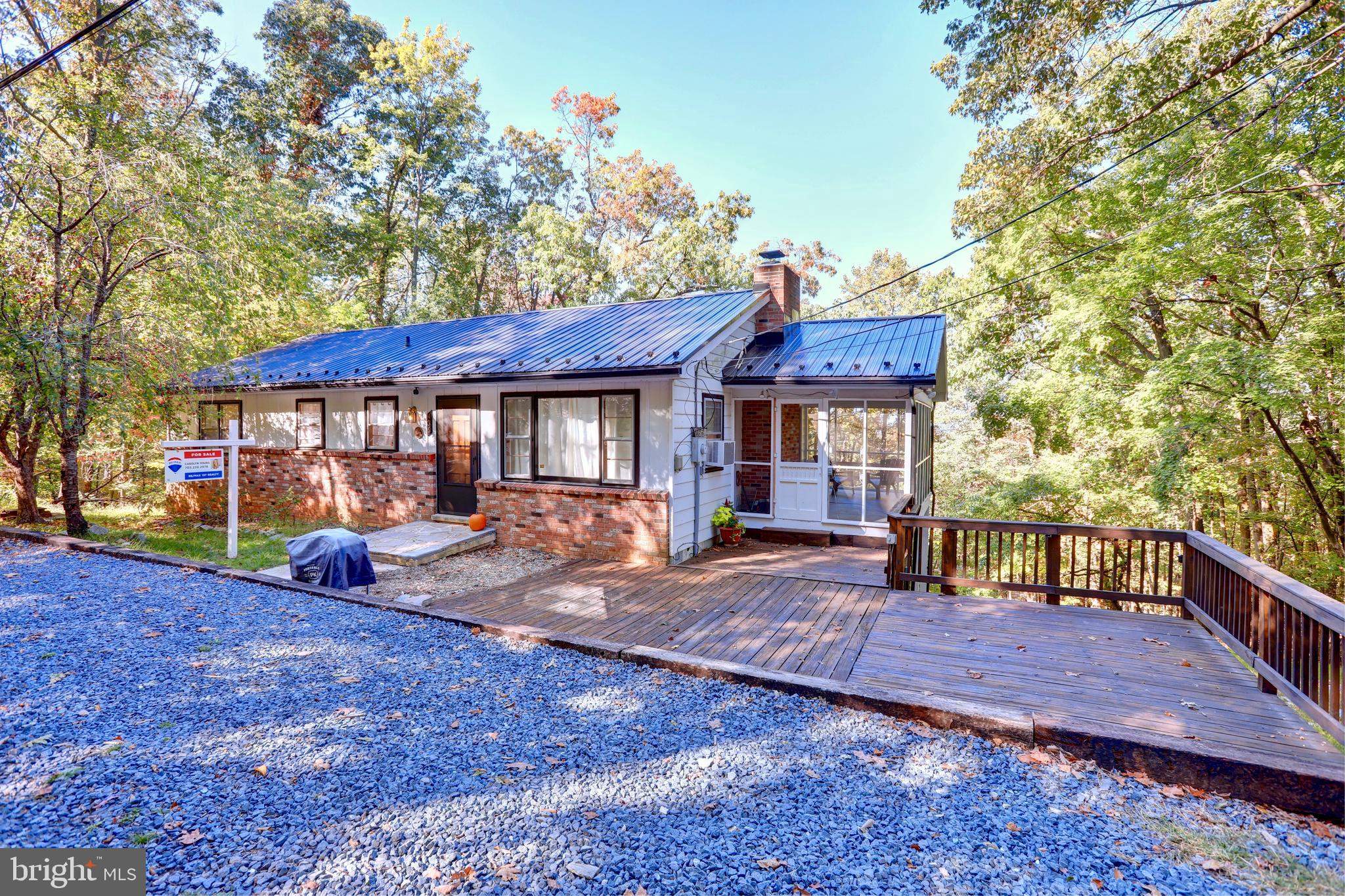 Absolutely charming 3 Bedroom 2 Bath Rancher with amazing views of the valley all while tucked away in your own private oasis! Resting on just under 1/2 acre this home has original hardwood flooring throughout the main level, spacious Family Room with woodstove, remodeled kitchen with butcher block countertops, fully renovated bath, and an unfinished lower level with walk out and second full bathroom. Relax on your front deck style porch or sip coffee on the side screened in porch area! *New gravel driveway, metal roof, culligan whole home water system, and baseboard heaters* This home is the perfect escape while still convenient to commuter roads and quaint towns such as historic Harpers Ferry and Charles Town. Endless possibilities - Main home, vacation home or AirBnB! A Must see!