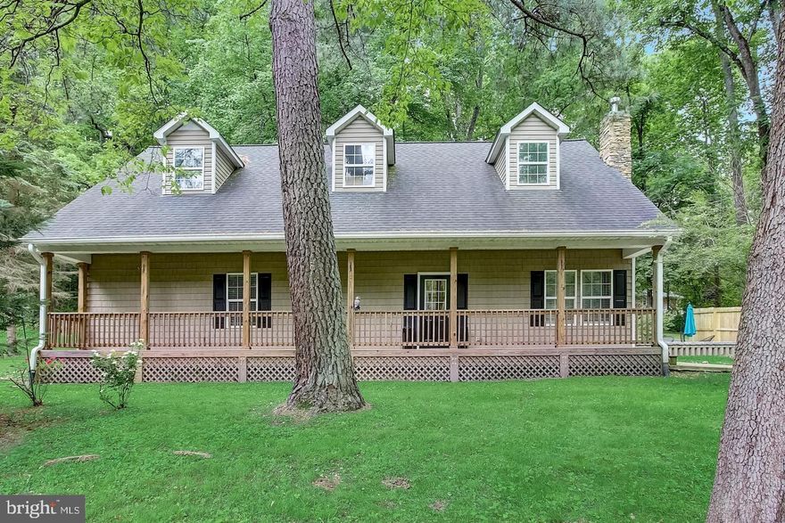 ***  VA  ASSUMABLE  AND  NO  HOA  FEES  ***    Custom-built in 2014, this charming rancher is ready to welcome you home! Nestled on 1.95 acres among mature trees, the property provides a serene retreat for nature lovers. Enjoy entertaining on your spacious paver stone patio or simply relax and take in the beautiful landscape. With convenient one-level living, the home features a living room with high vaulted ceilings, a cozy gas stacked stone fireplace, and new luxury vinyl plank flooring. The open floor plan, accentuated by dormer windows, floods the space with natural light.  The kitchen is a chef's delight, boasting granite countertops, a large island with new pendant lighting and stool seating, and black stainless appliances including a gas stove. The owner’s suite offers a vaulted ceiling, dormer window, two closets, and an en-suite bath with a two-sink vanity, tiled shower with semi-frameless doors, and a bench seat.  Additional highlights include pull-down attic access, ceiling fans in all three bedrooms, a laundry room, and a hall bath with a tub/shower combo.   The one car garage with carport is equipped with electric and a level 2 charger.   Local public marina, ideal for boating, fishing, kayaking, and personal watercraft activities. It boasts ample parking suitable for large RVs and boats. Additionally, the property offers its own ATV trails, enhancing recreational opportunities.  Conveniently located near Rts. 97 and 32, this home is also close to local shopping, restaurants, and Westfield Mall in Annapolis. Come and experience the perfect blend of comfort, style, and tranquility with many opportunities for family fun and enjoyment!