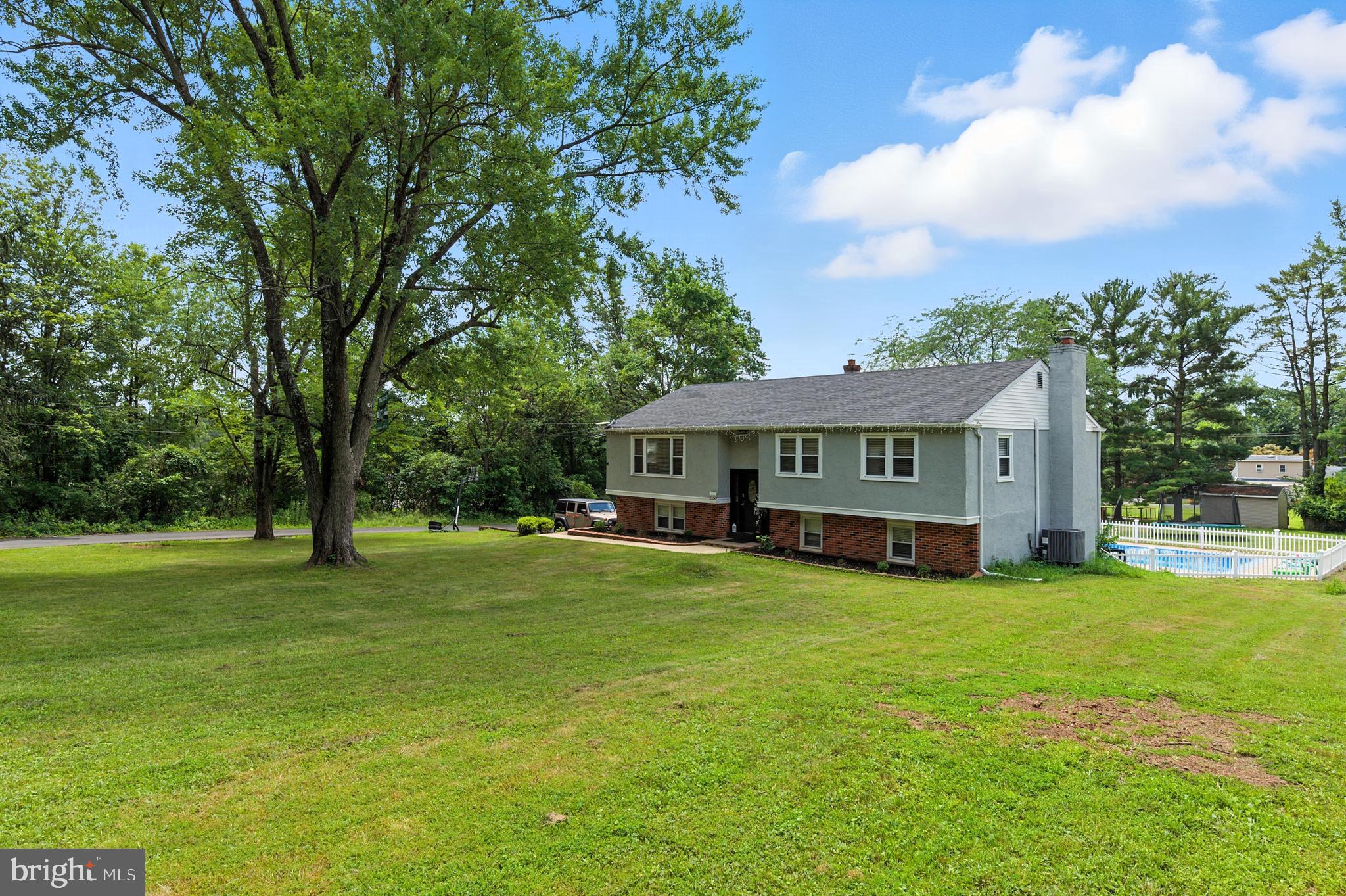 Welcome to 2150 Hilltop Ln, Warrington, PA 18976!
This beautifully maintained 4BR, 2BA home offers 1,994 sq ft of living space in pristine condition, located on a private road in the desirable Central Bucks School District. Featuring an open-concept layout with hardwood floors, a large sunroom overlooking the spacious yard and white picket fenced in-ground pool—perfect for entertaining!
The main level includes a generous primary bedroom with a large walk-in closet. The finished lower level offers a cozy man cave complete with a wood-burning fireplace. Additional highlights include a newer roof, heating system, and central A/C, plus a 2-car garage and oversized driveway fitting up to 8 cars. All situated on a 0.62-acre lot in a peaceful, convenient location. A true gem!