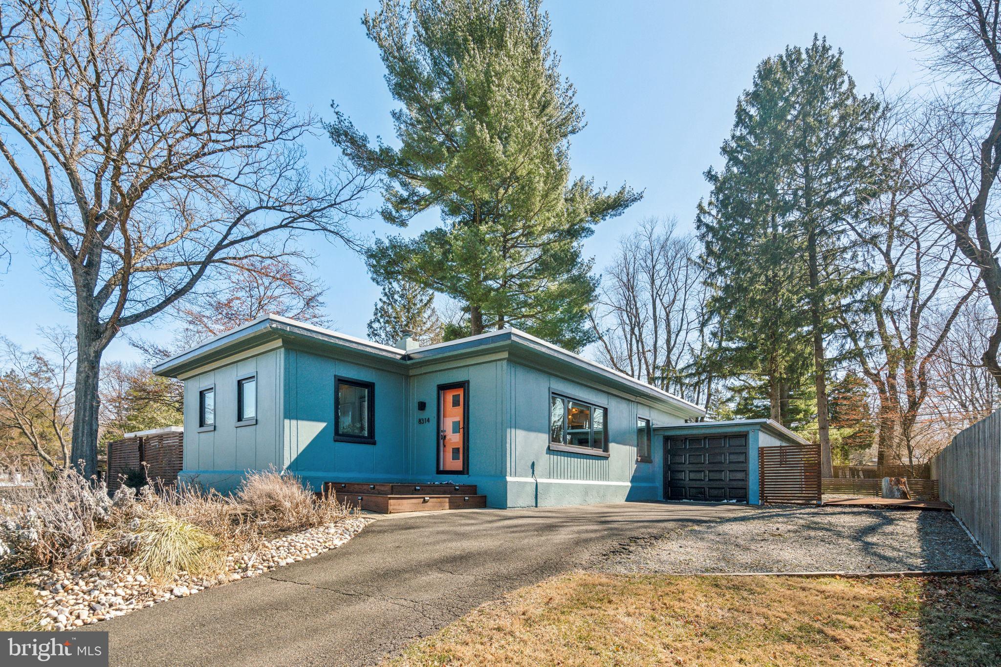 Gorgeous mid-century modern home with a large, lush backyard in highly sought after Wyndmoor! This house is nestled high off the street and is bigger than most of the other mid-century modern homes in the area because of the bonus addition. The house has 3 spacious bedrooms and a separate den plus 2 full bathrooms. The living room is soaked in sunlight and leads to a newer, eat-in kitchen with shaker styler cabinets, stainless steel appliances and granite countertops. There are 3 bedrooms plus a bonus room which is currently used as a home office but could be a nursery/media room/4th bedroom for guests, etc. The primary suite features a large bedroom with a wood burning fireplace, two large closets and a private bathroom with a glass-enclosed shower. Off of the primary suite is a brick patio which is ideal for morning coffee or al fresco dining. The backyard is perfectly level and is a private oasis. It’s well suited for gardening, playing games and/or outdoor entertaining. There’s more: coffered ceilings, newer windows, central air, separate laundry room, freshly painted throughout, and a full size garage. Great location! Blocks to the shops and restaurants in Wyndmoor such as Enza and Locals Coffee. Walk to Laurel Beech Park and Veterans Park. Walk to LaSalle College High School and enjoy the walking trails around campus. Minutes to the train station, Mount Airy and Chestnut Hill. Easy access to 309, Lincoln Dr and the PA turnpike.