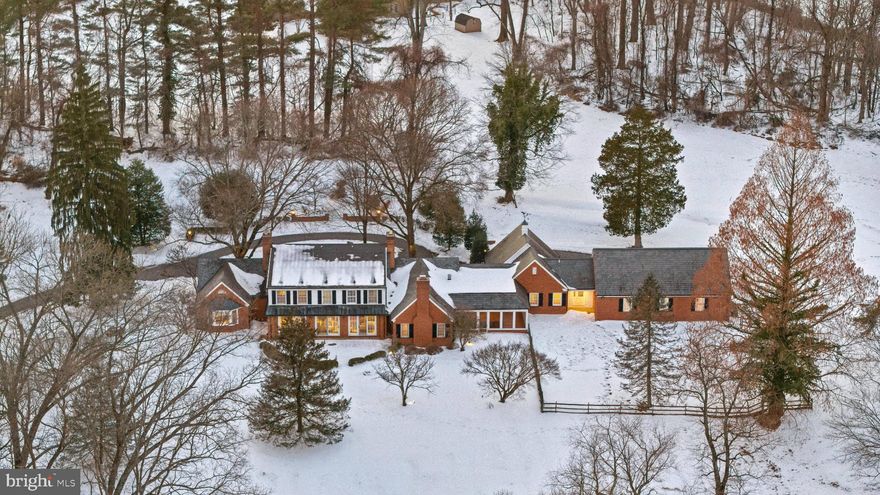 OPEN HOUSE Saturday, Feb 21 @ 12-2pm.  Perched on a serene 5.6-acre hilltop with commanding views, this expansive residence offers a rare combination of authentic craftsmanship and a relaxed country lifestyle. Offering 5,800 square feet of living space, 7 bedrooms, 5 full and two half-baths, the home’s substantial footprint was thoughtfully expanded by the renowned J. Paul Builders, creating a remarkable residence that prioritizes comfort and quality. From the durable slate roof to the high-end Marvin windows, the materials throughout reflect a commitment to quality and timeless design.  The main level has an ideal layout for both easy daily living and for entertaining family and friends. The gourmet kitchen features granite countertops, an work island, and a suite of professional-grade appliances, including a six-burner Thermador cooktop, Viking double wall ovens, and a Sub-Zero refrigerator, as well as a large walk-in pantry. The kitchen opens to a  dramatic great room with a vaulted ceiling, classic brick fireplace, and built-in bookcases. A dining room, living room, and large sunroom with a stunning view offer additional living space. The main floor is exceptionally versatile, featuring a spacious primary suite, a guest bedroom, and an additional room which could be a bedroom/home office/ playroom, alongside a dedicated art room to let your creativity shine. This wing could easily be updated to be a full private suite with a kitchenette, ideal for visitors or multi-generational living.   For those who appreciate the outdoors, the  sunroom, the screened-in porch with a built-in grill, and the outdoor stone patio all offer peaceful views of the lush yard. The upper level offers 4 bedrooms and 2 full bathrooms, including a convenient Jack-and-Jill configuration, all centered around an open landing. For even more utility, the lower level adds a finished area, a full bathroom, and extensive storage space.  Outside, the 5.6-acre grounds provide a private sanctuary of beautiful mature trees, plants, and flowers, with ample room for a future pool or custom hardscaping. The  4-car garage is equipped with a Tesla charger.  Located just minutes from busy shopping and dining options of Owings Mills and the scenic beauty of Greenspring Valley, this home offers a quiet retreat with easy access also to Stevenson, Hunt Valley, and downtown, and to 83, 795, and 695. This treasured property is ready for its next owners to enjoy and make it truly their own.