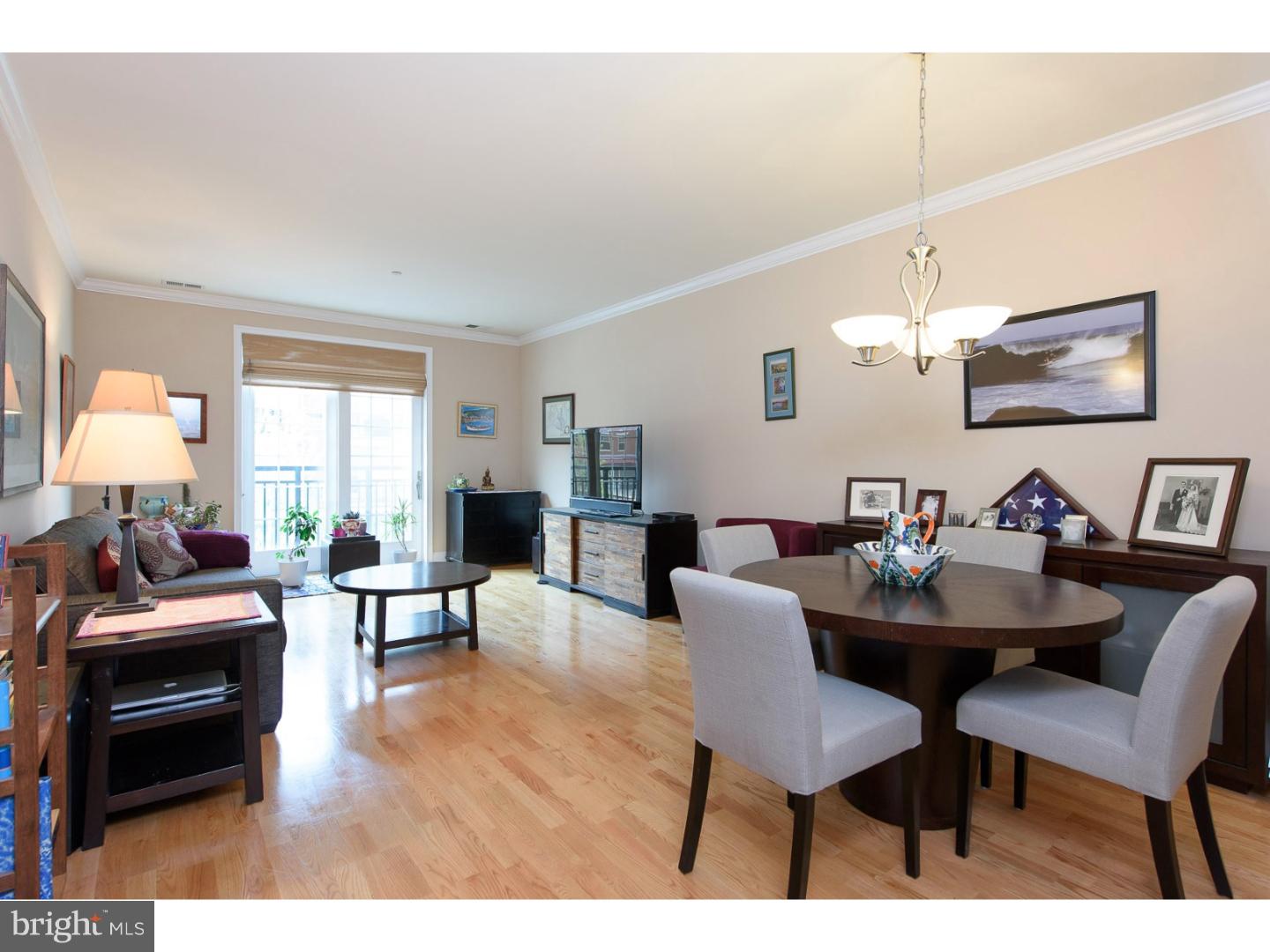 Extraordinary opportunity at Naval Square: Rarely available, perfectly maintained Sutton model! Featuring GARAGE PARKING and approximately 5 years of tax abatement remaining. This south-facing 2nd level home is located in Bainbridge Court only steps away from the pool & fitness center. Modern kitchen, complete with java cabinets, custom built-in pantry, and stainless Whirlpool Gold appliance suite. Granite counters & tumbled marble backsplash complete the space. Fantastic, sprawling living/dining area featuring neutral custom paint, recessed lighting, blonde oak hardwood flooring, and large Juliet balcony that allows an abundance of natural light. Beautiful master bedroom with oversized walk-in-closet & custom paint. Luxe hall bath features soaking tub/shower combo, granite counters & ceramic tiles. Full size side-by-side washer/dryer and large coat closet. 3 x 6 x 9 storage locker located within the building. All this with extraordinary Naval Square amenities: 20-acre park-like setting, concierge, state-of-the-art fitness center, seasonal pool, dramatic common spaces (available for private functions), free guest parking, gated community! Exceptional location for graduate students, faculty and residents. Close proximity to South Street Bridge, UPenn, CHOP, HUP, Fitler and Rittenhouse Squares and Schuylkill River Park, Trail & Boardwalk. Very low utilities & condo fees make ownership incredibly affordable. Don't miss your chance to own in Center City's premier gated community!