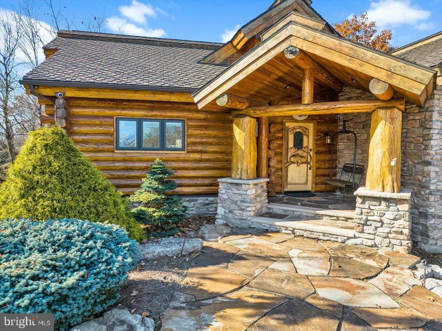 " The Cabin" as it is affectionately called is built on 2 lots at the end of a cul de sac in the magnificent Eagle Rock Resort community. Also included in the sale is an additional adjacent buildable lot if you choose to add on to the house or build a guest house or garage. The possibilities are endless.  Constructed of full diameter Douglas fir logs imported from Idaho and Brandywine Shadow Rock stone, this is an award winning log home in a prime location which will impress you before you even walk in. The main level consists of an open floor plan with cathedral ceilings, a great room boasting a gorgeous stone gas fireplace and a wall of windows to explore the magnificent view in the rear of the home. The kitchen includes custom cabinetry, a large curved island to seat at least four, granite countertops and stainless steel appliances. The adjacent dining area completes the main gathering space with an abundance of natural light flowing throughout. One of the two covered decks is accessed from the great room. The flooring on the entire main level is all solid hand planed hickory. Down a short hallway are the three bedrooms, the master suite includes a 2 person Jacuzzi tub, large walk in shower and a double sink. A private deck completes the master suite. Two guest bedrooms share a guest bathroom plus there is a powder room on this level.  
Take the elevator or walk down the stairs to the beautiful lower level where you will find the recreation room with pool table and other games, another stone gas fireplace, Italian cut stone floor, a large full-service bar with sink, beverage cooler, ice maker and dishwasher. The custom wine cellar has a 500-bottle capacity with cooling system. The lower level is where you will also find the laundry room, a separate pantry room with a large upright stand-alone refrigerator and freezer and spacious cabinetry. Another powder room is conveniently located nearby as well as an inside entrance to the garage. The recreation room opens to a very large patio with an outdoor kitchen area for barbecuing and entertaining plus a small, fenced yard to keep the dogs in and the deer out. The natural rock outcropping creates a secluded grotto effect for your relaxing pleasure. 
All windows and doors are Pella with e-glass, all bathrooms have heated tile floors, and the roof was re-shingled in 2020. The home comes completely furnished.
Although this lovely award-winning home is ideal for full time living, the amenities of Eagle Rock Resort make it a fabulous getaway for a four season second home with an approximate two-hour drive from Philadelphia or NYC. A few amenities in the community include 2 golf courses, boating, ski and snow sports, equestrian center, swimming pools, restaurant and more. Schedule your private tour of this fabulous home soon to start enjoying life here.
This listing also includes  Parcel # 26-U5S5-007044-000 (lot taxes are included in this listing)
