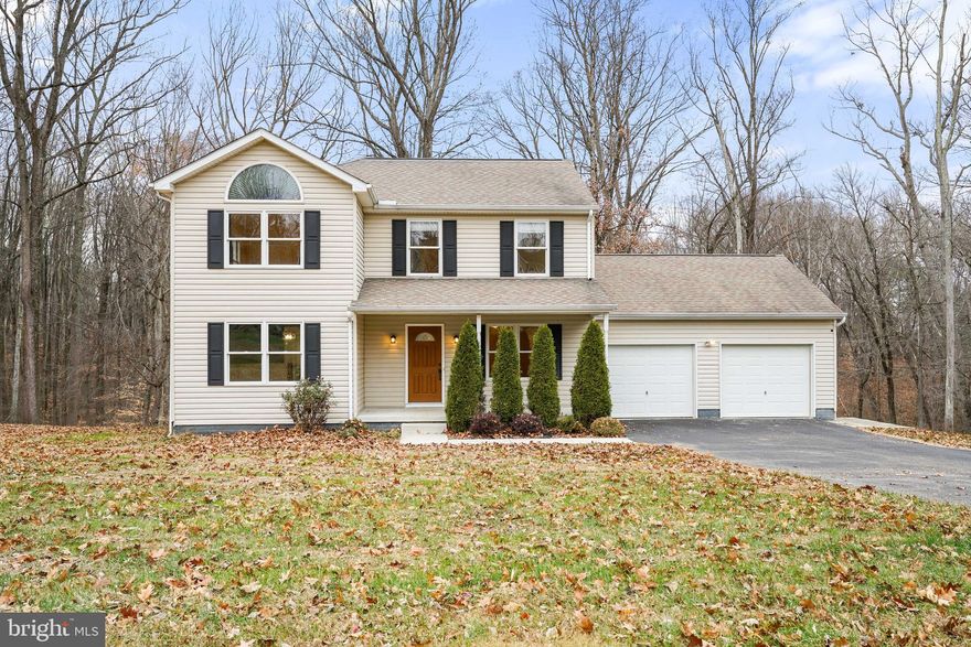 Fall in love with this well-maintained home tucked away in a serene setting! Enjoy the beauty of nature right from your backyard as the property backs to protected woods and a picturesque stream! Inside, you'll notice the beautiful Australian Cypress hardwood flooring throughout, adding warmth and character. The kitchen features Quartz countertops and stainless-steel appliances. One of the highlights on the main level is the sunroom, where walls of windows provide an abundance of natural light. A place where you can enjoy panoramic views of the outdoors! For your convenience, a separate laundry room is located on the main level. The upper-level features 3 bedrooms & 2 full baths. The primary bedroom suite boasts a dramatic cathedral ceiling. This spacious home offers additional finished rooms in the basement with endless possibilities such as an office, gym or hobby space. When retreating to the backyard, you'll find the gorgeous wrap around stone patio! The garage provides plenty of additional storage.  New hot water heater & the interior HVAC unit is only a few yrs. old. Though private, this home is just minutes from access to conveniences and Milburn Orchards!