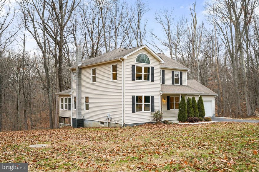 Fall in love with this well-maintained home tucked away in a serene setting! Enjoy the beauty of nature right from your backyard as the property backs to protected woods and a picturesque stream! Inside, you'll notice the beautiful Australian Cypress hardwood flooring throughout, adding warmth and character. The kitchen features Quartz countertops and stainless-steel appliances. One of the highlights on the main level is the sunroom, where walls of windows provide an abundance of natural light. A place where you can enjoy panoramic views of the outdoors! For your convenience, a separate laundry room is located on the main level. The upper-level features 3 bedrooms & 2 full baths. The primary bedroom suite boasts a dramatic cathedral ceiling. This spacious home offers additional finished rooms in the basement with endless possibilities such as an office, gym or hobby space. When retreating to the backyard, you'll find the gorgeous wrap around stone patio! The garage provides plenty of additional storage.  New hot water heater & the interior HVAC unit is only a few yrs. old. Though private, this home is just minutes from access to conveniences and Milburn Orchards!