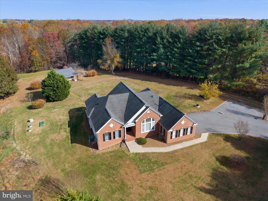 What a great place to call home!  Stunning and immaculate, this home has an open floorplan with amazing high ceilings, open kitchen to family room with fireplace and wet bar,  main level bedrooms and it's newly remodeled!  Spread out on 5 beautiful acres with no hoa, 3 main level bedrooms and 2 on the lower level with en suite bathrooms.  Enjoy a main level office area, enough room for entertaining and beautiful views off of the deck.  There is a spacious shed for your use as well.  The finished basement is huge and a fun place to enjoy with tons of storage area as well.  All of this within minutes of major transportation, shopping, restaurants, breweries and wineries.  Enjoy the holidays here!