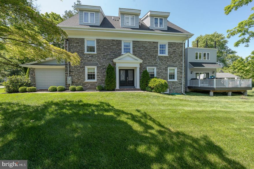 Stunning 2017 renovation by Nirvani Homes this classic center hall stone colonial has the appeal of a 1900’s classic Main Line estate on the outside with an updated and reconfigured interior to accommodate today’s modern lifestyle. Meticulously maintained and freshly painted throughout the fabulous floor plan, moldings, and custom finishes are evident even to today’s most discerning buyer. Approach the home along the Philadelphia Brick walkway and enter into a stunning foyer flanked by formal living and dining rooms accented with elegant moldings and wainscoting, each with a grand gas fireplace. The open eat-in cook's kitchen features beautiful marble countertops, peninsula seating, a custom built-in banquette with storage underneath, a 6 burner Wolf Stove, pot filler, a Thermador refrigerator, Kitchen Aid wall oven and separate convection/microwave oven, a wine refrigerator and an abundance of storage cabinetry. Adjacent to the kitchen is a rear covered porch entering a mudroom for convenient informal everyday use. The beautiful and bright Sunroom allows views of the rear yard, is bathed in light from windows on two sides, and has its own sink, 2nd dishwasher, and cabinetry. It walks out to a lovely patio perfect for grilling (gas line added) and outdoor entertaining. The sunroom would also make a convenient first-floor bedroom if needed as it is adjacent to a full bathroom. Adjacent to the living room is a wonderful, large home office with direct outside access that evokes a feeling of old-world charm with its original stone wall, built-in shelving, and original Philadelphia Brick flooring. The wide sunlit main staircase brings you to the luxurious master bedroom suite where you can find the third fireplace, a huge marble bathroom, complete with a walk-in shower, soaking tub, and dual vanities, plus a huge walk-in custom closet. The second bedroom suite on this level also has a spacious bathroom with a walk-in shower, separate jetted tub, radiant heated floors, and towel bar and offers an adjacent room perfect as a sitting area, homework space, playroom, or additional bed space. Ascending the skylit staircase to the third floor find 3 additional generously sized bedrooms each bathed in light with custom walk-in closets and one offering access to a new roof deck where you can enjoy an evening beverage under the stars or a coffee in the am overlooking the tranquil rear grounds. A skylit spacious full bath with a walk-in shower, separate soaking tub and dual sinks plus laundry complete this floor. The custom-finished basement must not be forgotten- it makes an ideal entertaining space or playroom with its 65' tv, linear fireplace, and gaming area. All this is set on over a half acre of sprawling level ground -fully fenced and large enough to accommodate a pool, outdoor kitchen, fire pit, playset, or your own personal putting green. Detached garage, new siding, new windows, new roof, newer 3 zone HVAC, new plumbing, new electric, 2 outdoor living spaces, and custom walk-in closets in every bedroom. Walking distance to the train, religious establishments, and shopping centers this ideal location in a coveted Main Line neighborhood in Lower Merion school district is in the choice catchment of either Harriton or Lower Merion High School and is not to be missed. Truly nothing to do but move in and unpack!