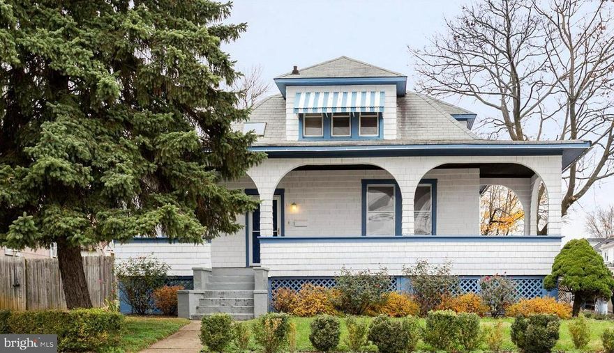 Step onto the inviting wrap-around porch featuring charming archways—perfect for relaxing in the shade and enjoying every season. Inside, you’ll find beautiful hardwood floors, classic wood trim, and abundant natural light flowing throughout the home. The spacious living room seamlessly connects to a formal dining room through elegant solid wood pocket doors. The large eat-in kitchen offers a center island and plenty of space for cooking and gathering.
Generously sized bedrooms include walk-in closets, providing ample storage and comfort. The expansive basement features high ceilings, a second full bathroom, and incredible flexibility—ideal for storage, a workshop, or the opportunity to finish and add over 700+ square feet of additional living space.
Step outside to a private, fenced rear yard with a garden area, perfect for entertaining or relaxing outdoors. The detached two-car garage with a gated driveway offers secure parking and endless possibilities—convert it into a home office, guesthouse, studio, or whatever suits your needs.