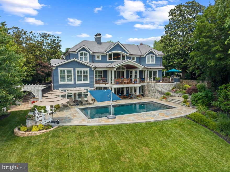 A rare opportunity on Spa Creek, this fully reimagined Murray Hill residence offers an extraordinary waterfront lifestyle just moments from downtown Annapolis. Completed in late 2023 after a full ground-up rebuild, the home spans 5,900+ sq. ft. of impeccably crafted living space, where natural materials, refined architectural details, and top-tier systems create a seamless blend of comfort and sophistication.

Set on just under a half acre of level waterfront, the property showcases one of the most complete private pier systems in the area: a heavily built main pier, two floating docks, and three boat lifts (16,000lb, 8,000lb, and 2,500lb), plus lighting, water, 30/50-amp shore power, Tide Slide moorings, and 6' MLW at the 70' T-head. A charming boathouse and waterside deck capture the magic of Spa Creek from morning to sunset.

Outdoor living is exceptional. A stunning 40' x 20' PebbleTec saltwater pool—rebuilt in 2024—anchors a series of Ipe decks and natural stone patios and decks designed for effortless entertaining. The outdoor kitchen with piped natural gas grill, refrigerator, and sink extends gatherings well into the warm months, while covered and uncovered spaces offer year-round enjoyment.

The exterior speaks to enduring quality with Carderock stone foundations, mahogany trim and ceilings, Loewen windows, Canadian cedar siding, copper gutters and flashings, and custom mahogany entry doors. A detached heated and cooled two-car garage includes a beautifully finished upper level with kitchenette, laundry, living/sleeping area, and private bath—ideal for guests or an au pair.

Inside, the home is defined by warm natural luxury featuring a stunning barrel vaulted mahogany ceiling with cove lighting. Additional curated details include: mahogany doors, black bronze hardware, 5" Cumaru flooring, custom cabinetry, and extensive millwork throughout. The chef’s kitchen features Sub-Zero and Wolf appliances with granite and soapstone surfaces. The main level Primary suite with inspiring view of pool and waterfront provides convenience and options for aging in place. The lower-level recreation spaces provide a relaxed retreat with a private bedroom suite, family room, wet bar, gym and full laundry room. An abundance of thoughtful design is presented throughout the home with multiple wet bars, radiant heated tile floors in five bathrooms and the main-level bar, and four separate laundry areas.

Less than half a mile from Church Circle, this residence delivers the rare ability to live on the water while enjoying the full walk-everywhere lifestyle of historic Annapolis. This is Spa Creek living at its finest: sophisticated, effortless, and undeniably special. Welcome Home!