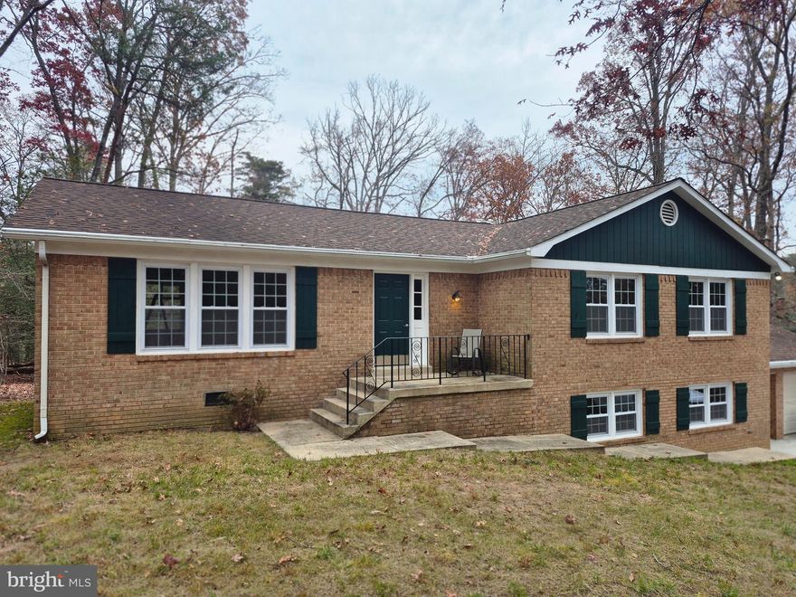 This is the home you have been waiting for! Nestled within almost 4 acres of trees, a true retreat! The home features 5 bedrooms, 3 full bathrooms, a formal dining room, living room and oversized family room on the  lower level.  There is a large laundry room with lots of space to use for storage.  The home has been updated with almost everthing new!  New paint, new flooring, new windows, new appliances, and bathrooms have been updated with everything new.  It is an all brick home with an  oversized 2 car garage. Located close to Routes 301 and 5 for easy access to the bases in the area and the beltway.