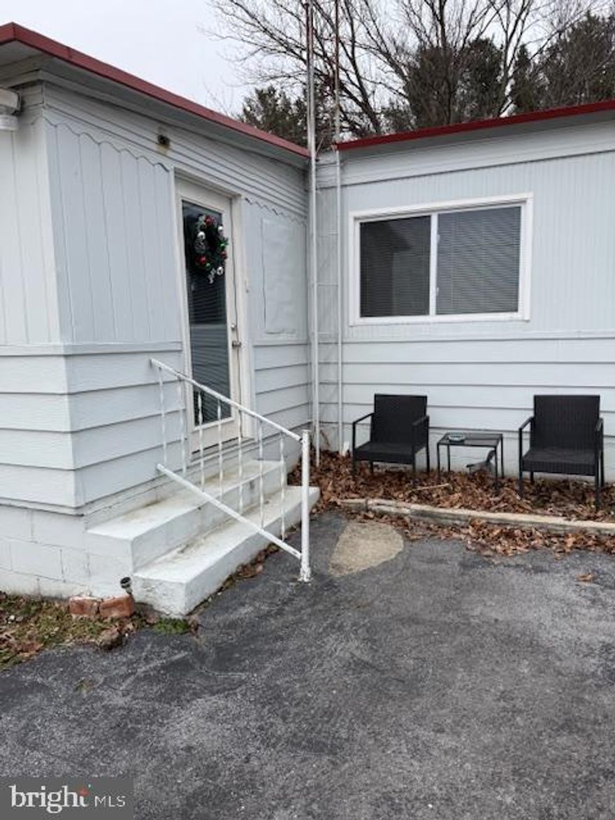Two bedroom, 1.5 bath mobile home with sunroom and storage room added in rear. Separate shed for storage. Level driveway. Updated laminate hardwood flooring throughout. Beautiful mountain views. Available February 1. Call for details and to schedule a showing.