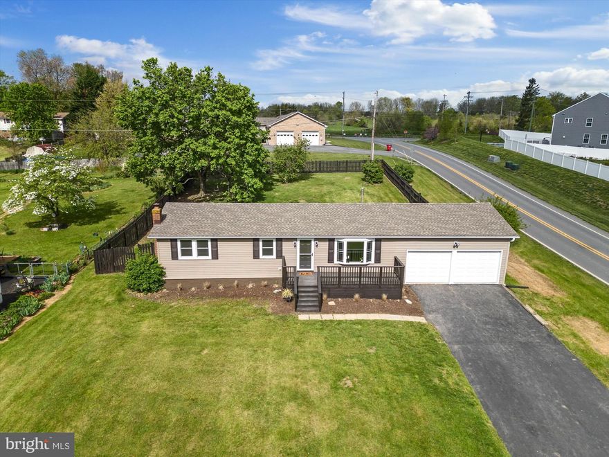 Exceptionally redesigned ranch-style home situated on a fenced, half-acre corner lot with a fully finished basement and 2-car garage! Centrally located just minutes from Rt. 340 and Rt.9 for easy access to all the area has to offer, this turnkey property provides over 2,000 sf of recently updated and functional living space. The original hardwood floors that traverse most of the main floor have been tastefully refinished, and other charming wood accents enhance the home's character. The kitchen features high-end countertops, a built-in seating bar, new appliances, and an attached dining area. The 3 bedrooms, all featuring gleaming hardwood floors, are on this level as well. The lower level has plenty of open space for whatever may suit your needs. Temperature control is provided by a brand new wood stove and 2 brand new mini-split units. The inviting front porch and back deck overlooking the spacious fenced yard are the perfect places to take in the beauty of the surrounding area. There's also an extended driveway providing plenty of parking. Homes with this much appeal at this price point are few and far between in Charles Town - don't miss out on this great opportunity!