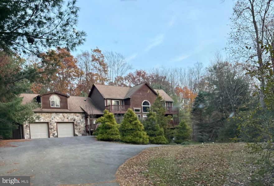 Subject to third-party approval as a short sale. Sold strictly 'as-is.' This home offers an opportunity to create your dream getaway or investment property. Featuring over 5,100 square feet, this 5-bedroom, 6 full bath, and 1 half bath home sits near Wisp Ski Resort and Deep Creek Lake, restaurants, shopping and entertainment on and off the lake, making it a prime destination for year-round recreation. There are generously sized living areas, fireplaces, and a large kitchen ready to be remodeled. Expansive front and rear decks provide space for outdoor entertaining or enjoying the surroundings. A two car attached garage adds convenience, while the property itself sits on over an acre of land, surrounded by mature, specimen-sized trees that offer privacy. Previously used as a vacation rental. The house does require updates and improvements throughout, including addressing mold-like/organic growth observed in the basement that occurred after pipe burst / leak.