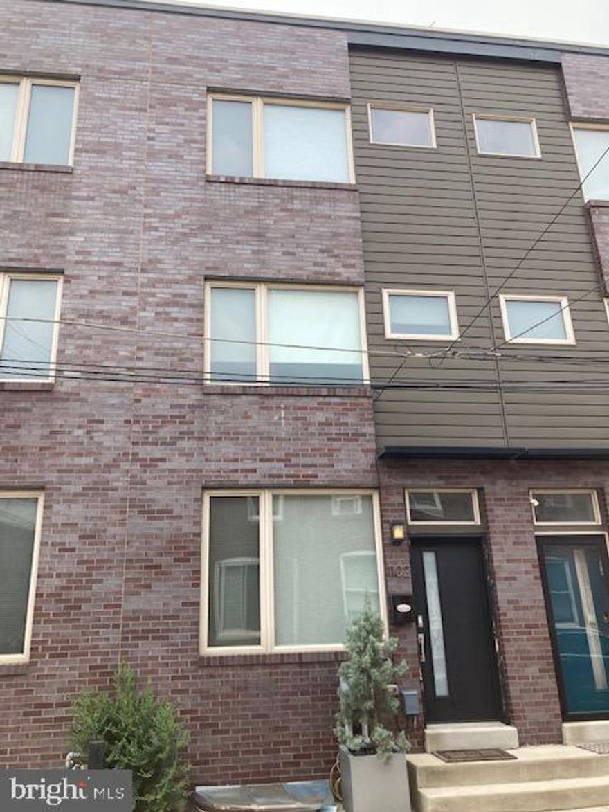 Welcome to 1102 E. Hewson Street – a stunning contemporary townhome in the vibrant Fishtown neighborhood of Philadelphia! This beautifully designed home, built in 2015, offers 4 bedrooms & 3 full bathrooms spread across 2,300 square feet of living space.

Interior Features: Open Floor Plan- Spacious living room flows seamlessly into the modern kitchen equipped with stainless steel appliances, granite countertops & a large island/breakfast bar. Hardwood Floors throughout the home, adding to its elegance and charm.

Upper Level: On the second floor, you will find two very spacious bedrooms with an beautifully-updated full bathroom. Up on the third floor, the master suite awaits you, with its amazing custom built-in cabinetry, with a walk-in closet and a stunning, upgraded master bathroom & large walk-in shower. 

Finished Basement: This could be described as a guest suite with over 700 square feet, currently used as a bedroom but can be an office, den or family room and includes a kitchenette, full updated bathroom, closet space and washer/dryer.

Rooftop Deck: Here’s the most enticing part of this property - the huge rooftop deck offering panoramic views of Center City Philadelphia and the Delaware River, perfect for entertaining or relaxing. 

Exterior Features:
Attached Carport- Two parking spaces right behind the property for easy access.
Private Gated Parking Lot- Ensuring security and convenience.

Location: Situated on a quaint street, just steps away from restaurants, shopping, and nightlife.
Convenient access to major highways, making commuting a breeze.
Green space development and walking park for residents right across the street.

This home is move-in ready and offers the perfect blend of modern living and urban convenience. Don't miss out on this fantastic opportunity to own a piece of Philadelphia's Fishtown!