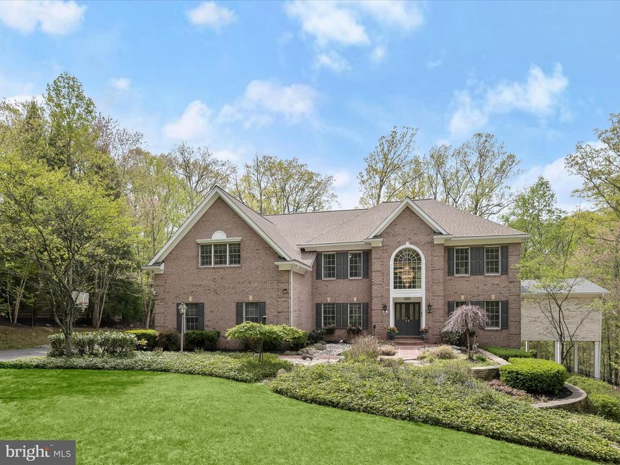 Welcome to your dream home, a stunning residence that perfectly blends privacy, luxury and comfort. Nestled on a private lot backing to preserve land, this property offers a serene retreat fringed by trees and cascading stone garden beds, located in a peaceful cul-de-sac.  A welcoming brick walk sided by garden beds escorts you to the brick front porch.  As you step inside, a grand two story foyer is sided by living and dining formals that are thoughtfully designed with pristinely refinished hardwood floors, a tray ceiling and decorative wall trim. The dining room transitions with a butlers pantry into the kitchen.  The heart and highlight of the home is the sparkling new gourmet kitchen, featuring quartz countertops, a commanding island and professional stainless-steel appliances and a gas cooktop with downdraft. In addition to new appliances, the kitchen showcases lots of beautiful cabinetry, up-to-the-minute designer finishes, stylish hardware and trending pendant lighting.  
A generous open plan unfolds seamlessly from the kitchen and breakfast area, into a dramatic two-story family room, creating a warm and inviting space for gatherings large or small. At the center of the storied family room, an impressive, stacked stone fireplace rises from floor to ceiling creating a comfortable and enduring aesthetic.  Recently added, a private main level ensuite bedroom with a stunning attached bath provides lifestyle options for in-laws, extended stays, or simply for main level living.  When the addition and kitchen renovation were underway, the idea for a second kitchen emerged and was implemented to provide even more flexibility for in-laws, caterers, or hosting guests. A main level laundry room, mud room and a central vacuum system with a kick vac around the island make daily clean up a breeze.   
Retreat at the end of the day by way of the private back stair in the kitchen that rises to the upper-level bedrooms.  Generously sized, the primary suite is outfitted with a sitting area, an attached private office with built-ins, two closets, two dressing closets and a spa-like luxury bath with separate vanities and a walk-in shower.  The upper level is completed by four additional en-suite bedrooms
Downstairs, Entertainment venues are endless, offering a theater room with risers and recliners, an adjacent wet bar, and an expansive recreation room with full daylight windows and a slider door for family and friends to meander outside to multiple patios, or visit the in-ground heated spa to relax and decompress. The fully finished lower level is completed by an exercise room, a sixth bedroom and a full bathroom.  Other outside venues include a screened porch that opens to a  deck with an outdoor gas cook station for BBQs and  dining for alfresco.  
Major upgrades and renovations in 2025 have ensured that this home is in excellent condition, ready for you to move in and make it your own. A side-entry garage and paved driveway will accommodate parking for guests, family, and friends. This exceptional property is a  place where people can grow while memories are made. With its perfect blend of luxury, comfort, and flexibility, this home is waiting for you to create your own story. Don’t miss the opportunity to make this enchanting residence your forever home!