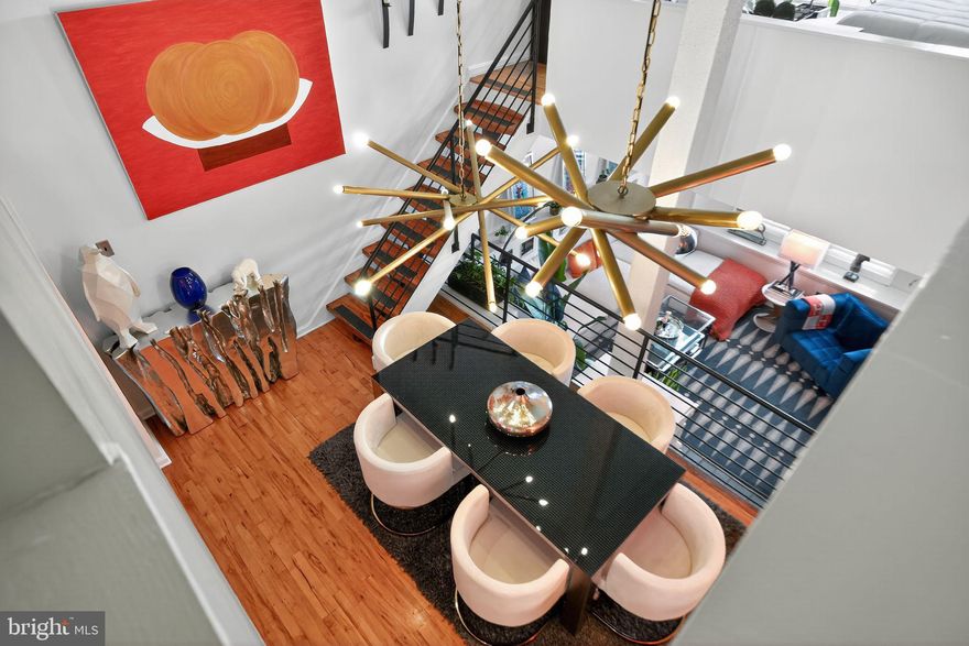 UPDATE: Accepting offers until 5 PM 11/4/25
Experience architectural brilliance and modern sophistication in this exceptional two-bedroom, one-and-a-half-bath residence spanning approximately 1,200 square feet in the heart of one of Philadelphia’s most desirable neighborhoods—Bella Vista. This isn't just a home, it's a lifestyle.

This dramatic, multi-level condo captures the essence of contemporary design with soaring ceilings, walls of windows, and striking sightlines that flood the space with natural light. Every level reveals a seamless interplay of modern materials and warm textures, from gleaming hardwood floors to sculptural lighting and refined finishes.

The sunken living room invites effortless relaxation with oversized windows and stylish designer accents—an ideal setting for entertaining or quiet evenings at home. A flexible lower space easily adapts as a guest suite, home office, or creative studio, enhancing the versatility of the layout.

Overlooking the main level, the formal dining area evokes a gallery aesthetic—airy, elevated, and connected—complemented by industrial-chic railings and elegant decorative touches and a soaring ceiling.

The chef’s kitchen is a showpiece of form and function, showcasing sleek white cabinetry, quartz countertops, a full suite of stainless-steel appliances, and a shimmering iridescent glass mosaic backsplash that catches the light beautifully.

The primary bedroom retreat feels serene and elevated, with green outdoor views, custom wall treatments, and spa-like ambiance. The renovated full bath is a designer’s dream—featuring dual vanities, a frameless glass shower, illuminated mirrors, and modern fixtures—while the half bath on the main floor adds stylish convenience for guests.

Additional features include custom lighting throughout, designer wallpaper, generous storage, and a floor plan that easily accommodates live/work flexibility.

Situated in the heart of vibrant Bella Vista, this home offers an unmatched urban lifestyle—steps from Whole Foods, Acme, the Italian Market, Hawthorne Park, Polumbo Rec Center, Segar Park and an array of cafés, boutiques, and acclaimed restaurants—all with easy access to Center City, transit, and major highways.

SHOWINGS AVAILABLE starting 12:00 Sunday 11/2.