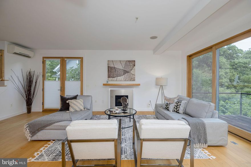 OPEN HOUSE THIS SUNDAY!

**Stunning Contemporary Split-Level Home offers Sustainable Design and Serene Setting**

Welcome to this exceptional home that seamlessly blends modern design, sustainable features, and a tranquil natural setting. With six bedrooms, four bathrooms, and more than 3600 square feet of living space, this property offers ample room for comfortable living and entertaining. Nestled amidst a beautifully wooded yard, the house boasts decks on every level, allowing you to immerse yourself in the serenity of the surrounding landscape.

As you open the front door, you'll be captivated by an open floor plan flooded with natural light, creating a warm and inviting atmosphere. The contemporary interior features maple floors that add elegance and charm to the living spaces. The main level encompasses a bedroom, full bath, a spacious living room, a dining area, and a gourmet kitchen with energy star appliances, harmonizing style with eco-consciousness. 

One of the highlights of this home is its commitment to environmentally friendly living. The sustainable design principles are evident throughout, with alternative energy sources and energy-efficient features. Solar panels adorn the roof, harnessing the power of the sun to provide clean and renewable energy and hot water. The mini-split HVAC systems ensure efficient cooling and heating. The pellet stove efficiently heats the main floors of the house, providing a cozy ambiance during colder months while reducing energy consumption. The landscaping focus heavily on native plants, supporting local biodiversity and minimizing the amount of watering required. 

The six bedrooms are spread across multiple levels, offering privacy and flexibility. An extra washer and dryer conveniently located on the bedroom level floor add to the convenience of daily living. The four well-appointed bathrooms, the main bath with a heated floor, provide comfort and convenience for all residents and guests.

Step outside onto the expansive decks and immerse yourself in the tranquility of a stunning backyard. The woody surroundings and soothing sounds emanating from the water feature create a peaceful retreat, perfect for relaxation or hosting gatherings with family and friends. The extensively landscaped section of the backyard is fenced in for privacy and security, with ample space to roam freely.  But the property line extends well beyond the fence into a large wooded area - a hidden gem of nature just one mile from the district. 

Just a few blocks from the Food Co-op, weekly Farmers' Market and multiple restaurants and shops.  Easy Metro and bus access. 

Don't miss the opportunity to own this remarkable home that combines modern living, sustainable features, and a serene natural setting. Schedule a viewing and experience the unique charm and eco-consciousness of this  extraordinary property.