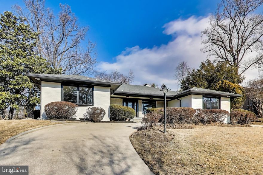 Stunning oversized rambler with a walkout basement. Be the home where everyone wants to gather! Your kids and their friends will flock to your house because it's across from Walt Whitman H.S.  How cool and convenient! While the original 1964 layout remains, this newly updated, stately ranch-style home in Bethesda has been transformed for today's lifestyle.  It offers flexible spaces perfect for remote work, kids' hangouts, or a dedicated fitness area—all within a thoughtfully designed layout featuring a walkout basement. The oversized, modern kitchen is a showstopper, featuring rich dark cabinetry, a gas stove with a pot filler, stylish fixtures and pulls, and a cozy fireplace—the perfect spot for cooking, entertaining, or unwinding. There's even room for a coffee or wine bar! Host in style in the formal dining room, which, with its original wallpaper, nods to the home's 60's charm. Alternatively, relax in the spacious living room, which is made for gatherings. With five bedrooms and 3.5 bathrooms, there's plenty of room for the kids, guests, and flex space. The lower-level rec room with a kitchen bar area will surely be a family favorite. The separate mudroom entrance to the laundry room adds everyday convenience, perfect for busy households. Move-in ready with brand-new windows, appliances, and flooring! Don't miss your chance to tour this incredible home in one of Bethesda's most sought-after locations.