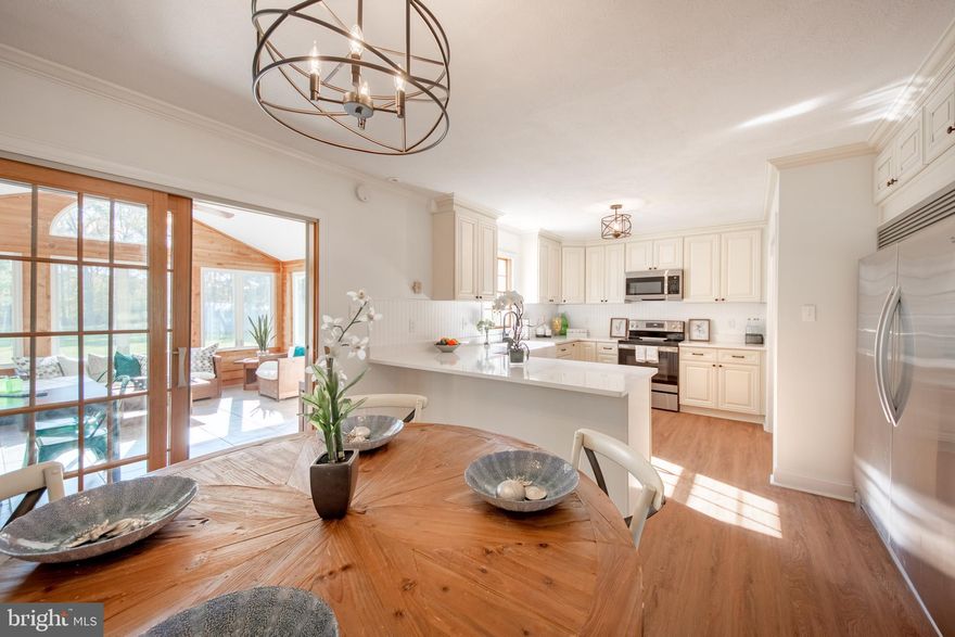 Truly unique opportunity to live in one of the most desirable properties in Tower Gardens!! This EXCQUISITE property is available for IMMEDIATE OCCUPANCY. Beautifully renovated 4BR, 3 FULL BA rambler home, offers serene living in sought after Tower Gardens community on Kent Island!! Enjoy your slow mornings or winding down in the evenings in the sunroom watching nature. Relax in the spacious living room with wonderful natural light, original hardwood floors and toasty pellet stove. The absolutely gorgeous, renovated kitchen and dining room feature brand new appliances, custom cabinetry and quartz countertops with a breakfast bar. There are two bedrooms in the main living area plus a fully renovated full bath with tub, and a third bedroom with another fully renovated full bath with tub in the center of the home. The spacious primary bedroom resides at the other end of the home with a walk-in closet, its own private bath and a sliding door to the very private backyard backed by gorgeous mature trees. Tower Gardens offers a community beach, boat ramp, playground, baseball field and community events. Don't miss out on your chance to enjoy this beautiful property!