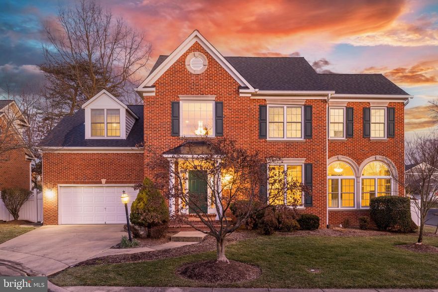 Welcome to 7950 Blitz Court in Dunn Loring, a remarkable all-brick four-level corner-lot home boasting four generous en-suite bedrooms, five-and-a-half baths, and a host of luxury appointments throughout. From the moment you enter the sun-drenched two-story foyer, you’ll notice the brand-new wood floors that flow into the dramatic main-level living spaces with soaring 10-foot ceilings. The gourmet kitchen is a showstopper, showcasing pristine white dovetail cabinetry, high-end quartz countertops, professional-grade appliances, and a built-in Miele coffee maker. An airy family room awaits just beyond, highlighted by its impressive 12-foot ceiling and one of two gas fireplaces. Upstairs, plush new carpet leads you to an expansive primary suite with a separate sitting area, walk-in closet, and a spa-inspired bath featuring dual vanities, soaking tub, and designer tile. The additional three en-suite bedrooms ensure convenience and privacy. Downstairs, the fully finished lower level offers a massive rec room, full bath, and a large den—ideal for a home office, fitness area, or guest quarters. Outside, the fenced backyard invites you to unwind on the flagstone patio amid pristine landscaping supported by an irrigation system, while an EV charger in the double garage speaks to modern amenities. Additional notable upgrades include a new roof (2020), hot water heater, two-zone HVAC with electric air filter and UV light (2024), Renewal by Andersen windows and doors (2024), new insulation, new screened gutters, and fresh carpet throughout. Perfectly situated on a .17-acre lot, this distinguished residence is minutes from Tysons Corner, The Boro, Mosaic, INOVA Fairfax Hospital, Dunn Loring Metro, and major commuter routes (I-495, I-66, and Routes 29/50), marrying timeless elegance with an unbeatable location.