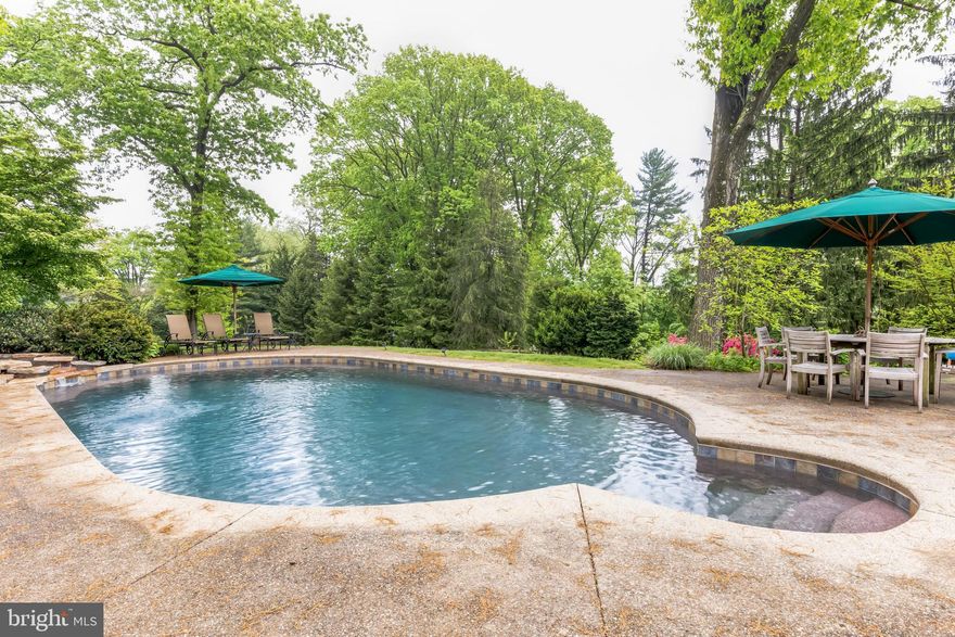 Welcome to this stunning stone home located in sought after Rydal. This beautiful home is sited on a 1.4 acre beautifully landscaped lot with mature trees, a circular driveway, and lush greenery that offers an ideal blend of privacy and curb appeal. The interior of the home is just as impressive, with elegant and inviting spaces for entertaining and relaxation. The covered front entrance welcomes you to the foyer which is flanked by a huge living room with gorgeous fireplace and hardwood floors which are throughout most of the home and a formal dining room with bay window allowing lots of natural light.  The gourmet kitchen is equally impressive, featuring custom wood cabinetry, granite countertops, large island, refrigerator drawers, ice maker, top of the line stainless steel appliances and a spacious, open layout that is ideal for the home chef who loves to entertain.  The kitchen opens to the spacious breakfast room with stunning stone wall and a breathtaking view of the backyard entertaining/pool area. The expansive family room is equally inviting, with stunning exposed beams, a massive stone fireplace, and charming built-ins. If you work from home, you will love the sunroom/office with views of the backyard making work from home much brighter!  A powder room completes the first floor. The second-floor features 4 spacious and inviting bedrooms with hardwood floors, ceiling fans, and wonderful closet space. The primary bedroom is a generous size and has an updated bath complete with his and her sinks, vanity area and tiled walk-in shower. The huge 4th bedroom is part of an addition and is big enough for a bedroom and den all in one! The 5th bedroom/office is on the 3rd floor and features hardwood flooring, vaulted ceilings, built-in shelving and desk area, which may soon be your favorite room in the house!  A walk-in attic is easily accessible for all your storage needs. The full basement has tons of potential to be finished into additional living space and offers storage and an outside exit. The rustic outdoor entertaining area is truly magazine worthy! Entertain away under your covered patio with vaulted ceiling, sitting area , stone (gas) fireplace, and fully equipped outdoor kitchen with counter seating. Escape to your own private oasis with a breathtaking fully fenced backyard featuring a heated, saltwater pool, hot tub, stone patio, and lush landscaping - a peaceful retreat for relaxation and outdoor living. Another patio off of the breakfast room is a perfect spot for dining al fresco. The oversized 3 car garage can house 3 cars and all of your toys. The location is fantastic-you are minutes to several train stations, Abington/Jefferson Hospital, schools, library, parks, Whole Foods, Trader Joe's, movie theater and more. HURRY!!!