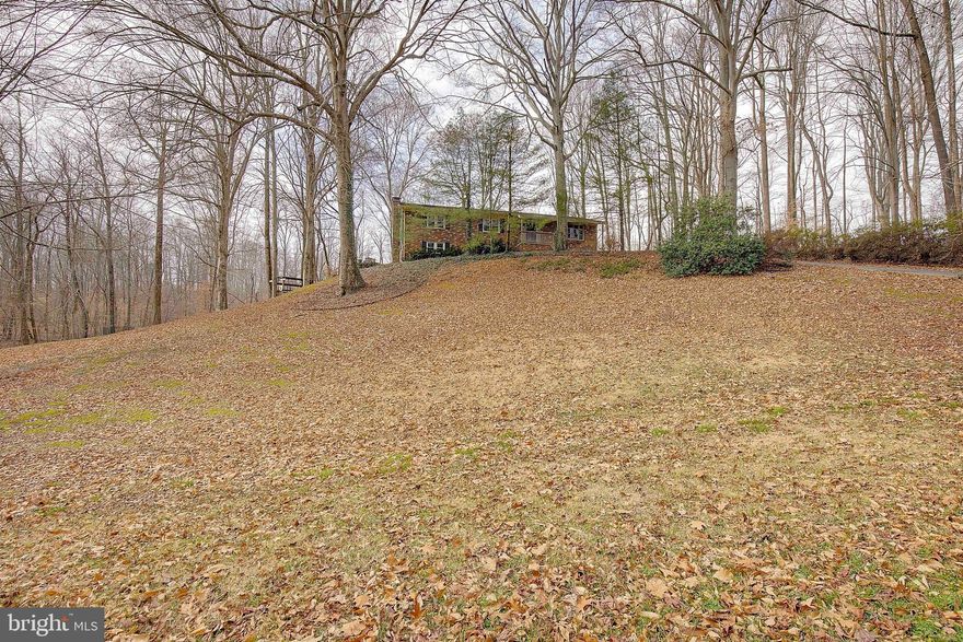 Enjoy the peaceful, rustic feel of nature in this spacious rambler with a full basement, set on a private 3.3-acre wooded lot in sought-after Dunkirk. Surrounded by abundant wildlife—including frequent deer sightings—this property offers true privacy while still enjoying a fantastic north-county location close to shopping, restaurants, and an easy commute to Joint Base Andrews or Washington, DC. This well-built home features three bedrooms on the main level, including a primary suite with a full bath, ceramic tile flooring, and a soaking tub. The walk-out lower level offers a functional fourth bedroom, a third full bath, and flexible living space ideal for extended family, guests, or multigenerational living, with sliding doors providing private access to the side yard. The expansive lower level includes a brick fireplace with a wood-stove insert, making it well-suited for a private living or recreation area and easily adaptable for an in-law or au pair suite. The main level has been freshly painted and all carpet is brand new!! The kitchen has granite countertops, stainless steel appliances, a gas range, and custom cabinetry, opening to a large country-style kitchen and dining area—perfect for gathering multiple generations. Additional living space includes a living room and separate family room with French doors leading to the deck, overlooking the serene wooded acreage. Main floor areas have original hardwood floors. Major updates include replacement windows, a roof installed approximately 10 years ago (2012), and a new drain field installed in 2005. A rare opportunity to enjoy privacy, flexibility, and space for multigenerational living—all in one beautiful setting!