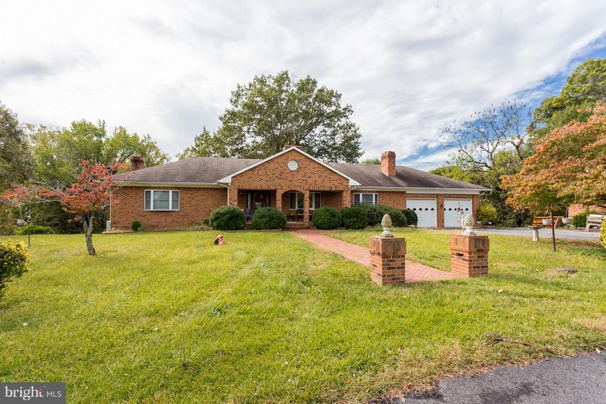 Over 4000+ sqft of possibilities. Great layout of one level living.  Brick front porch, Private brick upper level decks and brick lower level porch with arches.  Four fireplaces to keep you warm.  Four garage spaces for the toys. Almost 2 acres to roam about on.  Full Studio apt on LL with separate entrance. This house has enough extras to become a masterpiece, all it need is you.