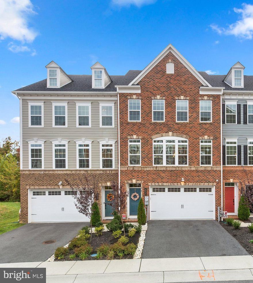 Backing to the Forest Conservation area and situated at the end of the cul-de-sac is this stunning brick front, 4-year new, 24 ft wide townhome with 9 ft ceilings and fresh interiors in sought-after Shipley’s Grant.  Step inside this 2,853 square foot home featuring an entry level true 4th bedroom, a full bath, a rec room with a French door stepping out to a stone paver patio, a fenced yard, and wood stairs to the core level.  The main level offers handscraped hardwood floors, a great room with 2 sets of French doors accessing an 8x20 low maintenance deck with beautiful wooded views, an open dining room with modern lighting, and a centered kitchen.  Chef minded, the kitchen boasts 42" white cabinetry, quartz counters, glass tile backsplash, stainless steel appliances including a 5-burner cooktop with a professional exhaust, a walk-in pantry, and a wonderful 13’ island with a breakfast bar accented by chic pendant lighting and seating for 5 .  Upstairs you find 2 good size secondary bedrooms and a grand owner’s suite presenting a tray ceiling with recessed lighting, a walk-in closet, a bank of windows, and a garden bath displaying a double vanity with granite top and a Roman step-in shower with bench seating and crafted tile work.  The laundry room with ceramic tile flooring is on the bedroom level.   This home has been lovingly maintained and most of the home has been painted in the past 2 years.  The entire main level, stairways and upper level hall have wood flooring.   The 2 car garage with some storage has epoxy flooring, outlet for charging an electric vehicle and painted walls.   This home has beautiful year-round views of lush green trees in the spring & summer, colorful fall foliage and snow-covered branches in the winter!!  Community amenities: expansive clubhouse which can be rented by homeowners for family events, 2 outdoor pools with sundeck, huge outdoor fireplace area, playground, shops, restaurants, offices, trails, a scenic farm and more!!  Best location in the Neighborhood backing to Forest Conservation and at the end of the cul-de-sac.   This is one of the few homes in the neighborhood with a deck and a large fenced in patio!  Close to major highways - Rt 100 & I-95, Shopping, Entertainment, Restaurants & Transportion.  Just 15-20 minutes from BWI Airport.
