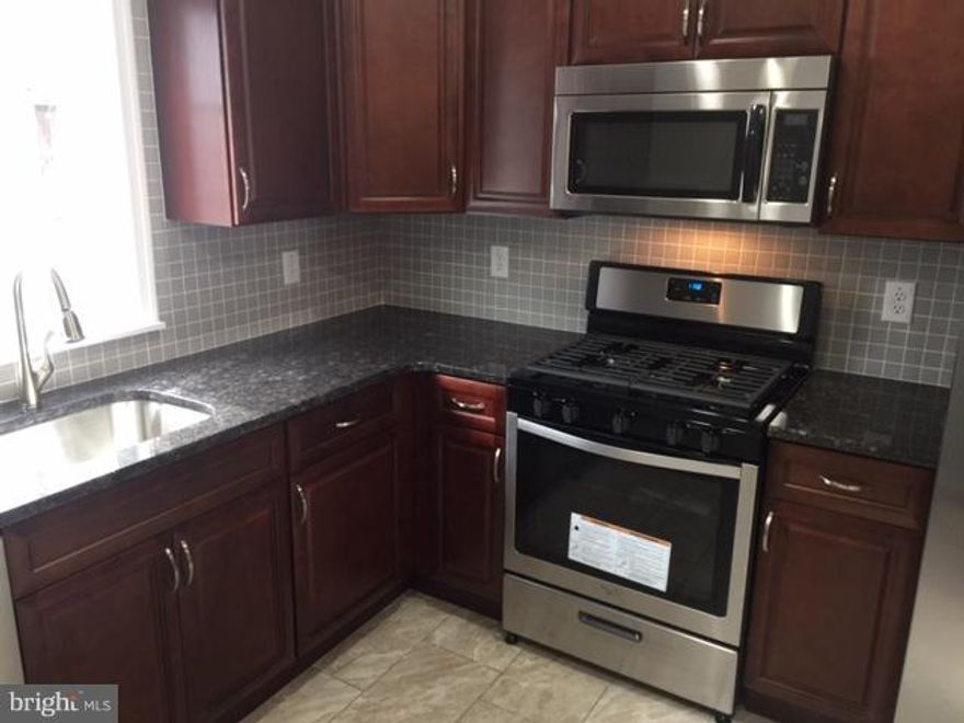 Completely remodeled - ready to move in.  Main Level offers new oak hardwood floor, all new kitchen with stainless steel appliances, granite counters, breakfast / bar granite counter,  gas cooking, recess lighting, crown molding. First floor new powder room.  Nice size deck out front , off street parking and 1 car garage. Second floor has two large bedrooms with refinished original hardwood decent closet space and beautiful new full bath. Also fully finished walk out basement with additional bedroom and full bath. More storage space and washer /dryer hookup.  All freshly painted in neutral modern colors. New water heater 2018, new A/C 2018, all new appliances 2018, all new windows 2018, new roof coating 2018,  new updated electric and plumbing 2018.  Schedule your visit soon.