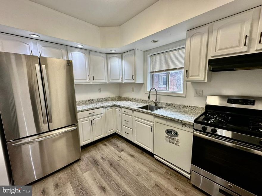 This spacious two-story brick row home offers a perfect blend of comfort and convenience. Fresh new paint, updated appliances. The main level features an expansive living room flowing into a formal dining area and a functional kitchen. Upstairs, discover three generously sized bedrooms with ample closet storage and a classic three-piece hall bath. The full unfinished basement provides extra storage, featuring walk-out access to rear parking and an attached one-car garage. Ideally situated near shopping, and major commuter routes.