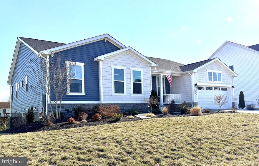 This is the one you've been waiting for!!  Showcasing exceptional designer style, this beautifully appointed 2023 built home lives like a model - elegant, effortless, and thoughtfully designed for modern living.  With main-level living and a finished lower level, the floor plan balances convenience and flexibility.  The open-concept main level features an airy great room with abundant natural light, a gourmet chef's kitchen with premium finishes and appliances, and seamless flow to a covered porch - perfect for great gatherings.  Tucked on a .28 acre lot, with a deep setback from the street, this home offers both presence and privacy.  The lower level extends the living space beautifully, providing a large recreation area, guest suite, another bedroom or office - whatever fits your lifestyle best.  Every detail reflects extraordinary care and taste - from the curated lighting to the designer color palette.  Comfortable luxury and timeless appeal - it truly doesn't get any better than this!