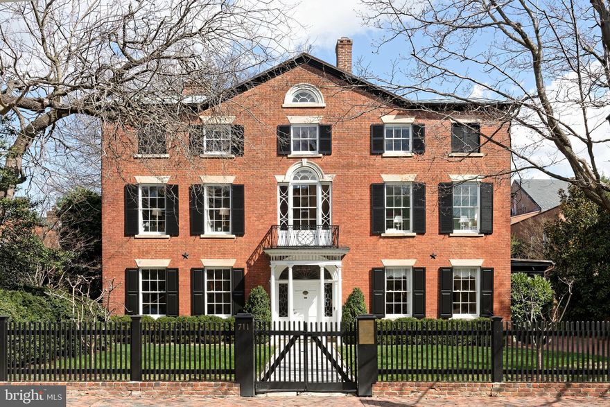 An Iconic Property Rich in History. Rarely does an offering like this come along, embodying a storied chapter in Old Town history. The Patton-Fowle House-attributed by some to renowned early American architect Charles Bulfinch of Boston-is one of America's finest examples of Federal high-style architecture, and among the largest, most distinctive gems in Alexandria, VA. This important landmark is protected by preservation easements in favor of the Commonwealth of Virginia and Historic Alexandria Foundation. Construction began in 1806 by James Patton and was completed in 1815 by wealthy shipping merchant and banker William Fowle of Boston. The home remained in the Fowle family until 1969, and has since been thoughtfully expanded, restored and modernized.  Magnificence in Every Detail. This exquisite freestanding residence set on spacious lushly landscaped grounds boasts 6 bedrooms and 5.1 baths, not to mention many wonderful period details and high-end upgrades. A covered porch and gorgeous entrance greet you upon arrival, graced by a leaded glass fan light & side lights restored by Mr. Goldkuhle, a famous leaded glass expert who helped restore windows at the National Cathedral. An original front door opens to a striking entry hall featuring a turned original staircase with shadow rail. Interiors impress with tall ceilings, original ornate plaster crown moldings, tasteful millwork, 8 lined fireplaces with original mantels & surrounds (several with coal baskets made in England which light with a gas flame), antique crystal chandeliers from England, and hardwood floors.   Exceptional Design and Comfort. While very grand, the home affords a comfortable, contemporary style of living desired by today’s discerning buyer. Perfectly proportioned rooms are designed for both intimate and large-scale entertaining. The large living room for cocktail parties and holiday gatherings, and elegant dining room for sit-down meals are very inviting, brightened by oversized windows. The new addition with a lovely family room is less formal and great for casual get-togethers and movie nights. A bar, fireplace, heated floors & sets of French doors enhance the ambience. The chef will be inspired in the gourmet kitchen equipped with honed marble countertops, a Lacanche French gas stove with double oven plus wall oven in the large center island, Sub-Zero refrigerator, 2 freezer & 2 warming drawers, and a wine fridge. An open breakfast/sitting room with fireplace has a window wall & glass doors to expansive terraces that stretch the entire back of the house. Outdoors is a dream for hosting and an oasis for relaxing with family, complemented by an enormous yard with mature trees & plantings. Electric driveway gates open to provide off-street parking for multiple cars. Rounding out the main level is a beautiful powder room.  Generous, Gracious Living. Ascend the staircase or take the elevator (which accesses three levels) up to a 2nd story landing showcasing a splendid Jeffersonian window and original ornate iron exterior railing. Your luxurious master retreat awaits, with remote-controlled draperies, original floors, a gas fireplace, phenomenal his & hers closets and new white marble en-suite spa bath with in-floor heating. Level 2 also has 2 additional bedrooms (one now used as an office) and a renovated bath. The top floor with a dramatic barrel-ceiling landing offers 3 more sizable guest rooms and 2 well-appointed full baths. The lower level haven presents a fabulous bricked wine room, exercise room with heated floor, laundry, full bath, and excellent storage areas.  Don’t miss this true treasure situated in the historical district, a short stroll to the waterfront and all the premium attractions for which coveted Old Town is known.
