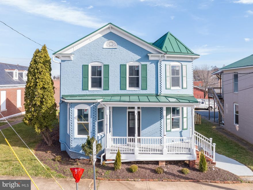 Discover a rare opportunity to own a piece of Charles Town history with this beautifully renovated 1885-built home, where timeless architecture meets modern updates.  This charming two-story property offers 2,128 square feet of versatile space with three spacious bedrooms, two full bathrooms, and zoning that allows for both residential and commercial use - at one time it served as a law office.  Inside, the home seamlessly blends classic character with thoughtful upgrades.  Enjoy new Luxury Vinyl Plank (LVP) flooring, energy-efficient windows, LED lighting, heat pump system, and a durable metal roof.  The stylish kitchen features granite countertops and ample cabinetry—perfect for everyday living or a hospitality setting.  Whether you're looking for a distinctive primary residence, a live/work setup, or a boutique professional space, this property adapts to your vision.  Its prominent road frontage in the heart of town ensures visibility and accessibility, while the rare 10-car private parking lot in the rear offers convenience rarely found in town. Two storage buildings and a fully fenced backyard enhance functionality.  The 0.20-acre lot also includes additional space beyond the parking area, providing potential for future expansion, outdoor seating, lawn or garden space. With walkable access to shops, restaurants, and local attractions, the location supports both vibrant living and commercial success.  Whether you’re drawn to its historical charm, modern comforts, or business potential, this unique property offers the best of all worlds.