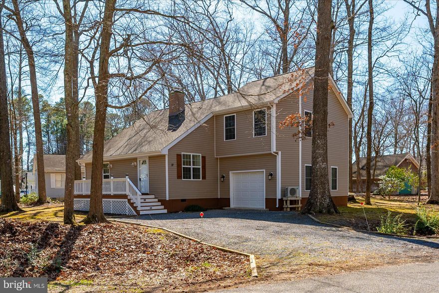 Welcome to this inviting cottage-style home nestled in the South Gate section of Ocean Pines. Thoughtfully renovated in 2016, this property features a new roof, windows, flooring, updated kitchen and baths, stainless steel appliances, heat pump, exterior siding, decks, and a screened porch. The living room is highlighted by a soaring vaulted ceiling accented with beautiful stained tongue-and-groove wood, creating a warm and airy atmosphere. The kitchen is well designed with generous counter space, a breakfast bar, and a spacious pantry. In 2017, the home was expanded to include a garage and a second-floor primary suite complete with a walk in closet and a private en-suite bath. Situated on a large corner lot, the property offers ample outdoor space to relax or entertain, with both a welcoming front porch and a screened rear porch. Enjoy all that Ocean Pines has to offer, including outdoor pools, a year-round indoor pool, tennis and pickleball courts, basketball courts, golf course, recreation and community center, marina, yacht club, boat ramp, and the Ocean City Beach Club with parking at 50th Street. This is a wonderful opportunity to own a home that combines charm, updates, and exceptional community amenities.