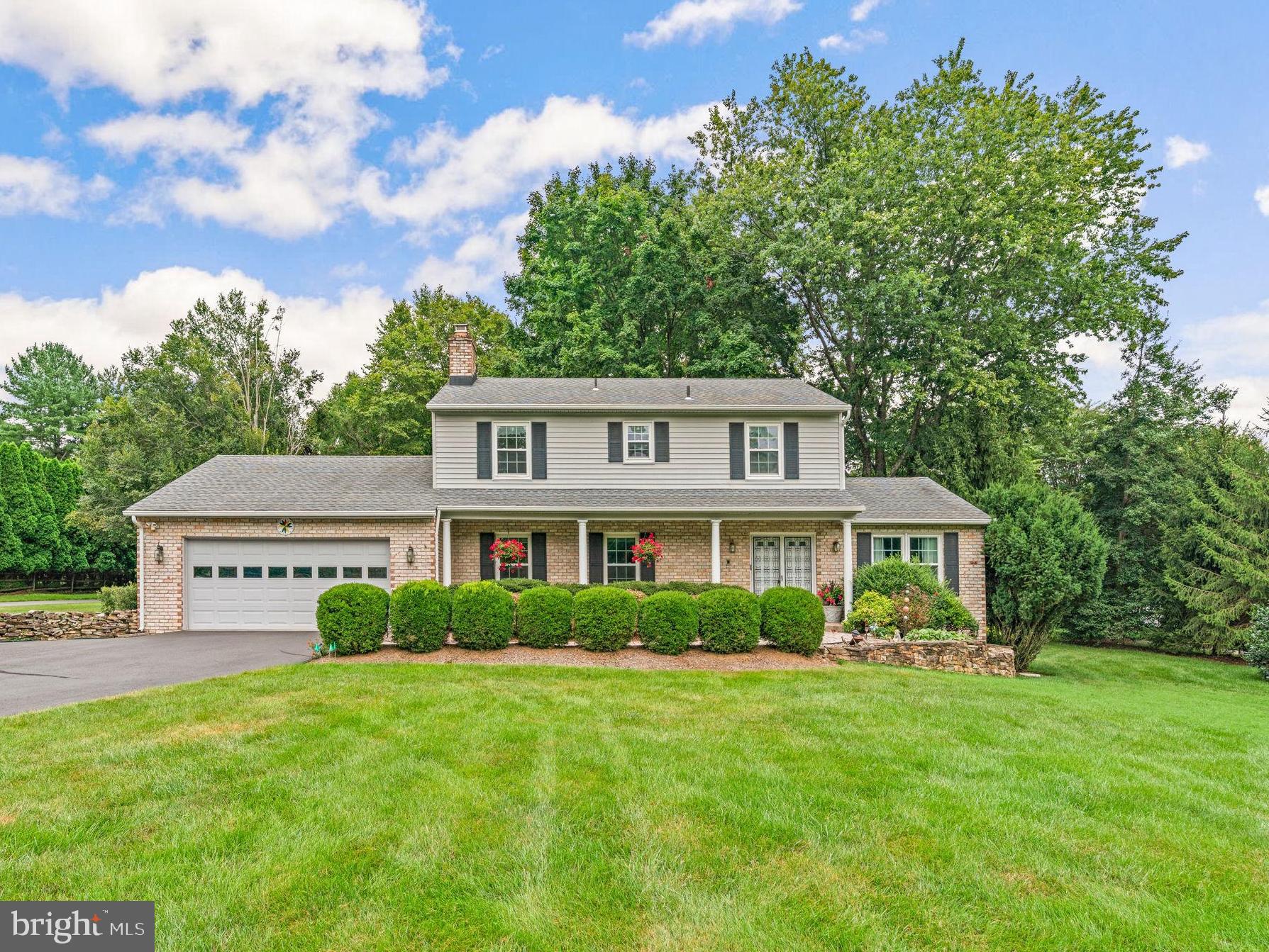Elegant Colonial offering 2,189 square feet with 4 bedrooms, 2 full baths, 2 half baths, and a 2-car garage nestled on a full acre in sought-after Highland, lovingly maintained by the original owners. This residence makes a striking first impression with its gorgeous curb appeal—lush landscaping, a stone retaining wall, an expansive front yard, and a long private driveway with ample parking. A shrub-lined stone walkway leads to the welcoming front porch and double front doors accented by a partial brick façade. Inside, the foyer opens to a bright formal living room and sliding doors to the deck. The layout flows seamlessly into the formal dining room, highlighted by gleaming hardwood floors, a sparkling chandelier, and a chair railing. The spacious eat-in kitchen features select stainless steel appliances, double ovens, abundant cabinetry and counter space, and a cozy breakfast area with access to the backyard and a laundry room with garage access. Completing the main level are two convenient powder rooms and a family room adorned with hardwood floors and a stunning stone-surround gas fireplace. Upstairs, discover four generously sized bedrooms and two full bathrooms, including the private primary suite with its own bath. The walk-up lower level offers excellent storage or the opportunity to customize for future living space. Outdoor living is equally inviting, with a wood deck overlooking the expansive, level backyard, beautifully landscaped and bordered by mature trees for shade and privacy.