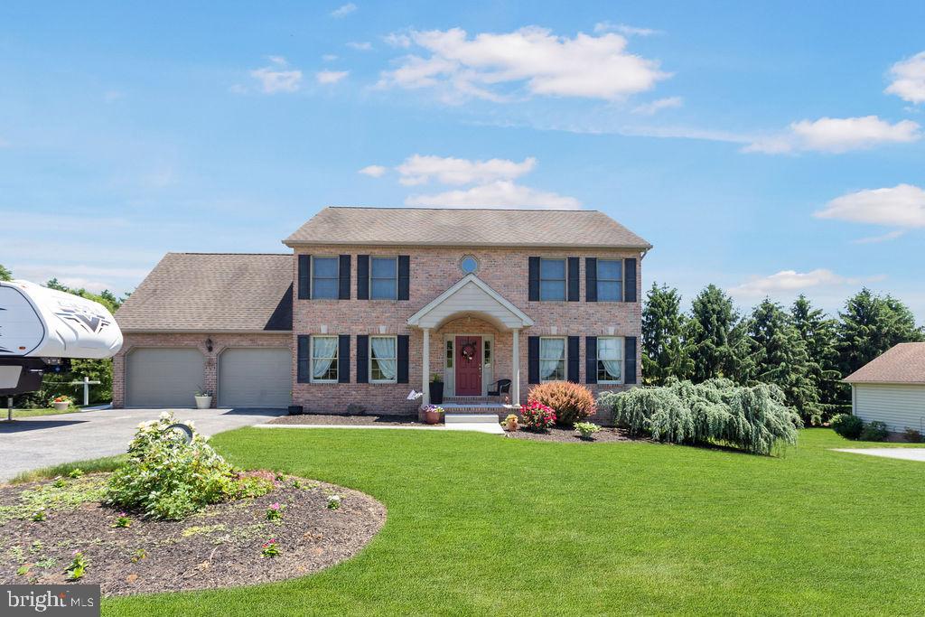 Welcome to this beautiful, well kept home in Spring Forge development. A friendly neighborhood with street lights, sidewalks, library and close to all the Spring Grove schools.  You'll fall in love with this charming home starting with the mature landscaping.  Entering the foyer you'll  find the formal living room and dining room tastefully  decorated with a neutral paint color and natural wood trim flowing throughout the rest of the house. An open kitchen with granite countertops and an island adjoins the family room which has a lovely stone floor-to-ceiling gas fireplace. (laundry room off kitchen with lots of storage) If that isn't enough to meet your entertaining needs, the family room leads to a sunroom with vaulted ceilings with wood beams and plenty of windows bringing the outside in.  The second floor boasts 4 bedrooms including a large master suite that has a 7 x 22 walk in closet and bonus area for storage!!! The attached bathroom has a double sink, soaking tub and walk in shower.  There is also a small room on the second floor that the owners use for an office, the original house plan called for this to be the laundry room.  Out back you'll find a  large composite deck (22 x 14) off the kitchen with retractable awning stepping down to a large patio (22x11) to enjoy relaxing time with family and friends. The shed (12x20) with overhead door is big enough to store all your gardening equipment. The basement is a blank slate ready for you to make your own. It has a separate room for a work shop and double door walk-out access to outside, and lots of shelving for storage.  This beauty is conveniently located between York and Hanover, nearby restaurants, grocery store, a portion of the rail trail, parks for the family and a dog park.