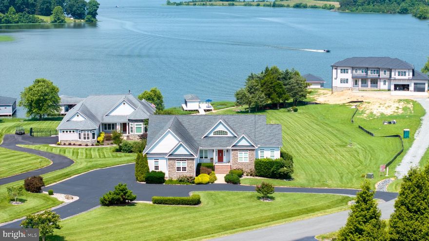 This isn’t just another lake house — it’s a high-quality, meticulously maintained home designed for comfort, flexibility, and timeless style. Every detail reflects care and craftsmanship, from the soaring ceilings and oversized windows that flood the space with natural light, to the well-planned layout that makes everyday living and entertaining effortless.

With over 3,600 sq. ft. of finished space, the home offers 4 bedrooms, 3 full bathrooms, and thoughtful touches throughout. The kitchen features granite countertops, stainless steel appliances, and abundant workspace. The open floor plan connects seamlessly to dining and living areas with panoramic lake views. A sunroom with walls of glass keeps you connected to the water year-round, whether it’s sunrise coffee or sunset evenings.

The main level offers true one-level living with a primary suite and private balcony overlooking the lake, an additional bedroom, full bath, and laundry — all just steps from the attached two-car garage. The fully finished walkout lower level adds a second kitchen, living room with gas fireplace, two bedrooms, a full bath, second laundry, and a bonus room, making it ideal for guests, extended stays, multi-use living, or hobbies.

Outside, the property shines with a rare, wide-open backyard leading to 125 feet of private shoreline and a well-built boathouse with upgraded decking, an electric lift, and a reinforced seawall. The lot offers privacy, space for recreation, and room for future additions like a pool or event area — all while keeping the lake just steps away.

Set in one of Lake Anna’s most desirable neighborhoods on the public side, you’ll enjoy peace, privacy, and quick access to The Boardwalk’s dining, entertainment, and shopping. Short-term rentals are allowed, and most furnishings, the golf cart, and even the boat are negotiable.

If you want a home that’s as impressive in quality as it is in location, this is it. Schedule your private showing today. **Watch the video tour and also check out the 3D tour.**