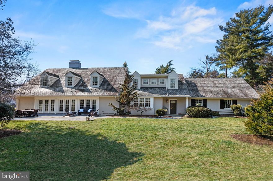 Refined luxury in the heart of Guilford. Fully renovated and thoughtfully expanded in 2013, this exceptional Cape Cod blends timeless architecture with modern sophistication. Offering 5 bedrooms, 3 full baths, and 2 half baths, the home is designed for both elegant entertaining and everyday comfort. The main level features rich hardwood floors, stunning millwork, double-hung Pella windows, and a seamless floor plan. The gourmet eat-in kitchen opens to the dining &  living spaces and includes an 8-foot island with seating, built-in banquette with park views, five-burner gas cooktop, double wall ovens, stainless farmhouse sink, wine refrigerator, coffee station, walk-in pantry, custom cabinetry, and designer lighting. A welcoming living room with gas fireplace, a family room, a first-floor guest suite, and custom mudroom with cubbies complete the main level. Upstairs, the primary suite offers a walk-in closet with custom built-ins and a beautiful  bathroom with double vanities and oversized walk-in shower. Two additional bedrooms, a shared bath, and convenient second-floor laundry complete the upper level. The fully finished lower level provides a fifth bedroom, full bath, expansive recreation/media space, and generous storage. Outdoor living is equally impressive with a bluestone walkway and patio overlooking Sunken Park, enhanced landscaping and lighting, enlarged gated driveway, and attached two-car garage.  A rare opportunity for turnkey living  in one of Baltimore’s most distinguished neighborhoods.