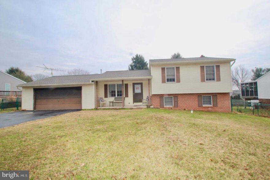 Great split level in Country Community yet close to town with large level & fenced yard. 5 yr young roof & replacement windows. Hardwood floors, living room & dining room. Maintenance free deck for  enjoying your yard. Lovely oak kitchen w-newer stainless appliances. Over sized 2 car garage.  Seller will give a $3,500 credit at settlement for cosmetic upgrades if buyers choice.