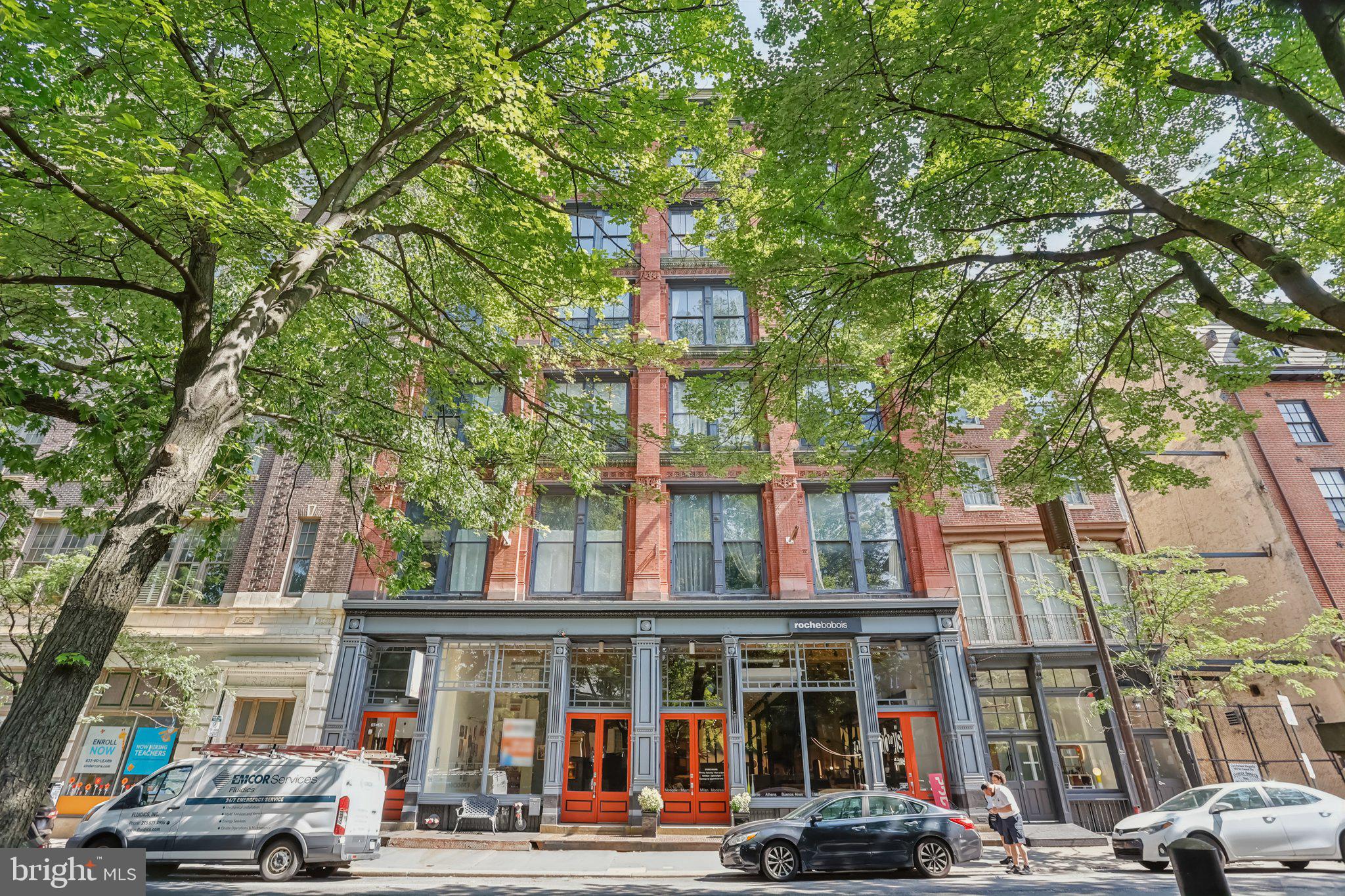Enjoy character and charm in this unique loft condo set within a beautifully converted hoopskirt factory in the heart of Old City. This distinctive residence showcases historic industrial details like exposed brick walls, original wood beams, and soaring 14-foot ceilings, blending timeless architecture with modern living. The spacious open-concept living and dining area features oversized windows. A stylish eat-in kitchen features a breakfast bar, tile backsplash, stainless steel appliances, new garbage disposal, pantry, and abundant cabinet and counter space. Upstairs, the lofted bedroom offers warmth with a striking wallpaper accent wall, a large custom closet, and an ensuite bathroom complete with a new toilet and walk-in shower. Just blocks from SEPTA transit, iconic historic landmarks, art galleries, and an array of restaurants, this one-of-a-kind condo offers the best of city living with undeniable character.