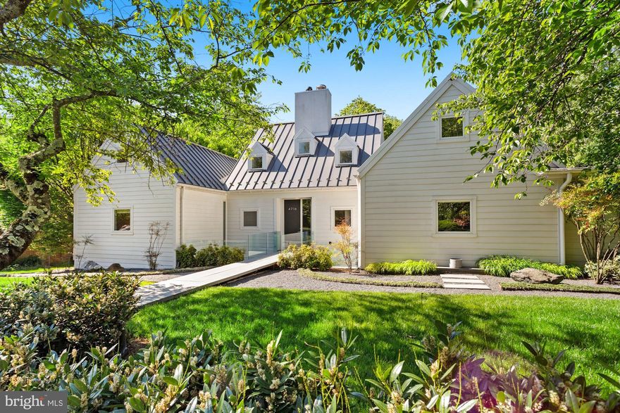 The hard to find main level primary suite is here on a quarter-acre lot in Somerset! This stunning, award-winning contemporary, whose design was adapted from Hugh Newell Jacobsen's "Dream Home" and built in 2007, has approximately 5,300 square feet of space. Offering soaring ceilings, walls of windows, gorgeous hickory floors and fabulous entertaining and everyday living spaces, the home brings the outdoors inside yet maintains incredible privacy. The center pavilion of the home includes entry foyer and a living room with 20' ceilings, a linear gas firebox and walls of glass into the expansive, domed screened porch and to the marble patios and heated saltwater pool beyond. A large chef's kitchen with custom cabinetry, island with seating for four and dining area are found in the west wing of the home, along with powder room, mud room with laundry, access to the attached 2-car garage and stairway to the lower level. Three bedroom suites, including the primary suite, are found in the east wing of the main level. The primary includes sumptuous bath, and two walk-in closets, one of which is a custom Poliform closet and could also function as additional living/work space. Each of the other two bedroom suites includes a loft area. A very generously sized family room is found on the lower level, along with three additional bedrooms (one is currently used as a gym) and two more full baths. There is also a kitchenette with wine cooler, plus a second laundry area and a separate entrance on this level. Gorgeous marble patios and decking overlook the heated salt-water pool, set among lovely plantings and green space. Somerset is beloved for its welcoming community, fabulous schools, neighborhood pool and fantastic location between Friendship Heights and Bethesda, with access to both metros and shopping. Numerous parks and playgrounds are also nearby, as is the Capital Crescent Trail. This is a truly special home in an unbeatable spot!