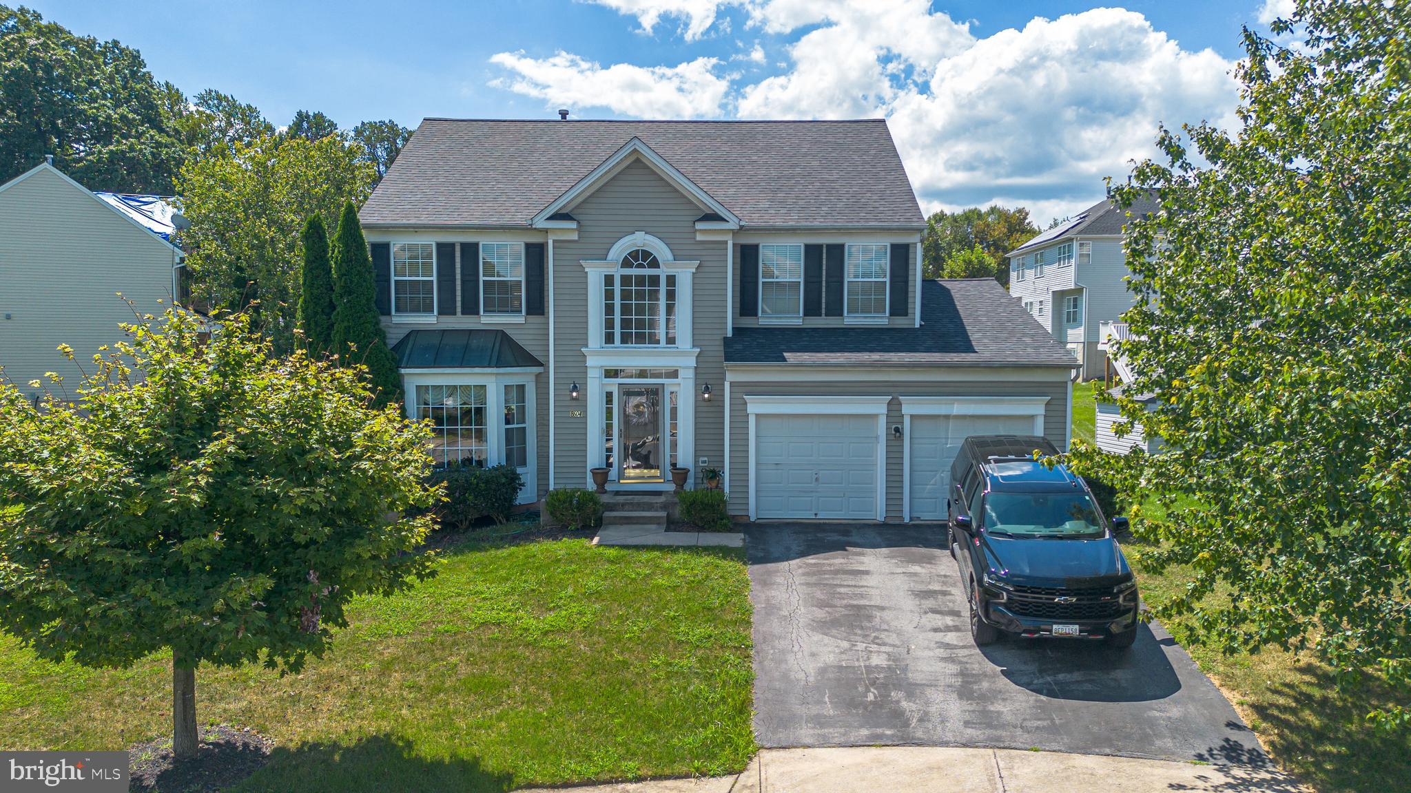 Experience the epitome of luxury living in this stunning Colonial residence nestled in the desirable Woodbrook community. This meticulously maintained 6-bedroom home, with a major renovation completed in 2024 (roof, deck, and central AC), showcases an exquisite blend of modern elegance and timeless charm. Step inside to discover an open floor plan that invites natural light to dance across the gleaming wood floors. The gourmet kitchen is a chef's dream, featuring upgraded countertops, a spacious island, and ample table space for casual dining. The dining area, adorned with crown moldings and chair railings, sets the stage for memorable gatherings. Retreat to the fully finished basement, a versatile space perfect for entertainment or relaxation, complete with a connecting stairway for easy access. The luxurious primary bath offers a serene escape, while the cozy fireplace in the living area creates an inviting ambiance for chilly evenings. This home is equipped with high-end appliances, including a gas oven/range and a convenient dishwasher, ensuring that every culinary endeavor is a delight. Security is paramount, with an alarm system providing peace of mind. With a generous lot size of 0.18 acres, the property features an attached garage with front entry and additional off-street parking. Enjoy the exclusive lifestyle that comes with living in Woodbrook, where every detail has been thoughtfully curated for your comfort and enjoyment. Don't miss the opportunity to make this luxurious haven your own!
