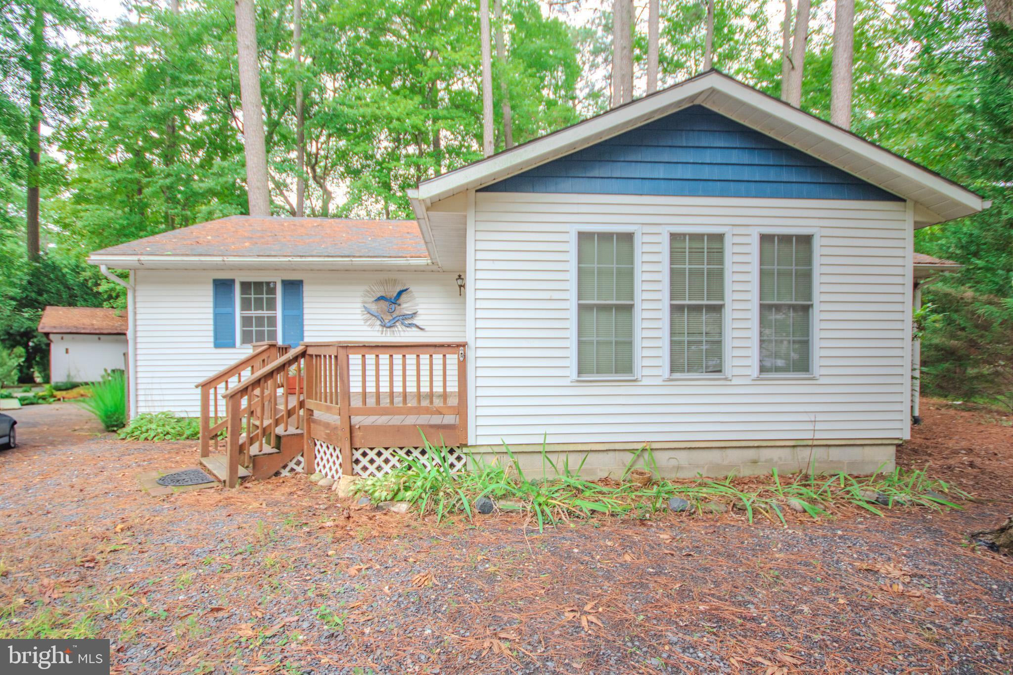 Welcome home to 9 Yeoman Drive. This adorable rancher is tucked away on a quiet cul-de-sac in the Huntington section of Ocean Pines. Located just inside the north gate, you are a short drive to route 90 and easy access to Ocean City. Lots of local shopping and doctors’ offices. This home boasts a lovely sunroom on the front of the house. The living, kitchen and dining area are one large open room, which feels even bigger with the vaulted ceilings. This beach house is ready for winter with its wood burning fireplace, to keep you cozy and warm. It also has a beautiful brick chimney for extra charm. As you head down the hallway you will see a separate laundry room, two extra bedrooms and a full hall bath. At the end of the hall, you will find the primary, complete with walk in shower. If you enjoy outside living, you will love the large rear deck, perfect for relaxing or grilling. The backyard feels very private, with trees and even bamboo. This could be the perfect place to make your own. *Some listing photos are virtually staged.