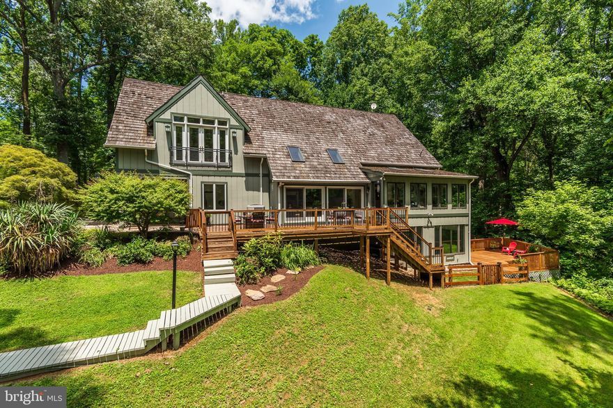 OPEN HOUSES CANCELED!! Property under Contract!  Nestled on a stunning 10-acre lot at the end of a rustic road in Spring Meadows/Harlow, this distinctive property embodies superb architectural detailing, a harmonious blend of indoor and outdoor living, modern amenities and a convenient location. The short drive along Poplar Hill Rd, with a delightful journey through woodlands under large tree canopies, sets the tone for the natural wonderland that abounds. Thoughtfully designed, expanded and renovated, this peaceful retreat meets the demands of modern life converging modern luxury with natural beauty across three light filled levels. As you approach the residence, a newly paved driveway with accent lighting leads to the gracious covered front entry. Once inside, soaring ceilings, floor to ceiling windows and skylights create exceptional light filled living. The open two-level design offers superb gathering space for everyday living and entertaining. A newly renovated center-island kitchen boasts new recessed panel cabinets, new Silestone countertops, new/newer stainless-steel appliances, a coffee bar area, and panty with new sliding doors. The gourmet kitchen opens to a sunroom/breakfast room with wall-to-wall windows, providing beauty and tranquility with gorgeous views of the woodlands. The family room offers stunning architectural detailing including a vaulted ceiling with exposed beam and skylight, a fireplace with a soapstone hearth, decorative stone surround, wood mantle and wall sconces. The light filled two level living room boasts two slider doors and skylights, providing picturesque views and access to the raised deck. And a separate dining room allows the natural beauty of the surrounding take center stage with three picture windows. An open hardwood staircase beautifully integrates the living space and leads to the upper level, where you’ll enjoy rich hardwoods, an open hallway with linen closet, a luxurious primary suite with full bath, two additional substantial bedrooms and a second full bathroom. Expanded and beautifully renovated, the primary suite addition provides a luxurious retreat. Designed with your comfort in mind, this special living space includes an elevated 12’ ceiling, French doors, four windows, two walk-in closets and built-in display shelving. Retreat to the primary bathroom where you’ll discover an oversized soaking tub with jets, separate shower, double sink vanity with rich cabinetry, custom tile surround, decorative glass transoms, wide plank tile flooring and two large casement windows. The open hallway leads to the second and third bedrooms, each substantial in size with hardwood flooring and sizable closets. These two bedrooms share a newly renovated full bathroom. Relax in the fully finished walk-out lower level, which includes the fourth bedroom, a third full bathroom, a theater room, an office and exercise room/sunroom. An ideal gathering space, the spacious theater room features a second renovated fireplace with soapstone hearth, wood mantle and sconce lighting. The light filled fourth bedroom features two tall windows and a slider door, providing access to the exercise room/sunroom. An adjacent full bathroom with tub and decorative tile, offers two separate vanities and two toilets. Ideal for remote work, the office includes built-in shelving, two casement windows and a slider door, leading to a flagstone walkway and stunning stone wall at the rear of the property. The lower-level sunroom is a multi-purpose space with wall-to-wall windows and a slider door leading to the the lower deck. The lush 10 acres of woods, including a hidden meadow, a running creek and trails provide an incredible opportunity to commune with nature, providing a unique living experience. This special Darnestown retreat is conveniently located only moments away from nearby natural attractions, local area shops/restaurants and key commuter routes. Welcome & Enjoy!