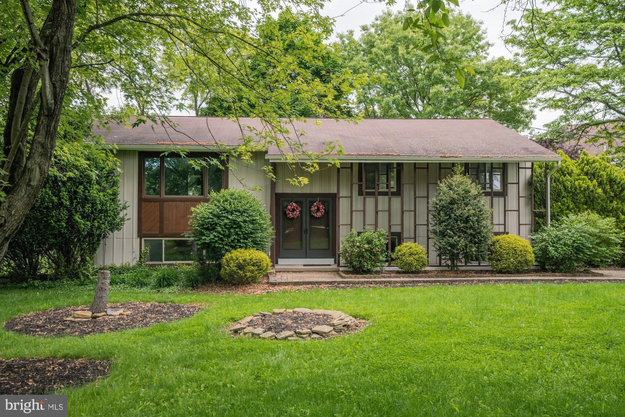 Stylish and welcoming, this beautiful custom home is situated on an exceptional, landscaped one acre lot.  Offered for sale by its original owner, this mid-century multi-level displays plenty of character with attractive coffered ceilings, hardwood flooring, tiled bathrooms, a contemporary balcony, and assorted vintage elements.   The spacious Great Room and giant Family Room with raised hearth gas fireplace are ideal locations for large gatherings.  Enjoy scenic views of the landscaped grounds from the three decks and paver patio courtyard.  One of the nicest lots in the area, the scenic one acre property features tall shade and ornamental trees surrounding the home plus a giant  back yard offering an expansive lawn area for all sorts of recreation.  Central Air.  Lots of closet space. Side-entry Garage. A one year "America's Preferred Home Warranty" is included.  Great location,  close to shopping, parks, and major commuter routes.