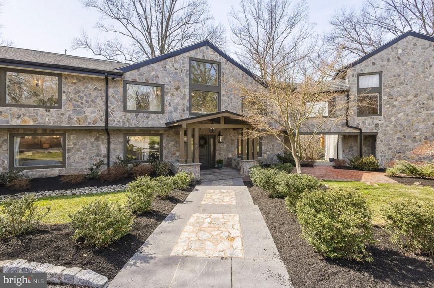 Stunning home on one of Penn Valley’s most desirable streets. Extensively renovated in 2019, this exceptional custom home offers 6 bedrooms, 7 full baths, and 1 half bath across more than 8,000 square feet of beautifully designed living space. Privately situated on a 2.78-acre interior lot, the home showcases a sophisticated transitional style, oversized windows, and wide-plank hardwood floors that have just been newly refinished.

A striking entry opens to an expansive, light-filled layout where the grand kitchen and dining area flow seamlessly into a breathtaking two-story great room. Featuring exposed beams, a dramatic floor-to-ceiling stone gas fireplace, and walls of glass, this space leads to a serene rear deck overlooking the landscaped grounds and resort-style pool.

The chef’s kitchen is both elegant and functional, complete with a massive quartz waterfall island, custom wood cabinetry, dual sinks, two dishwashers, and high-end stainless steel appliances. The main level also includes two bedroom suites with private baths, a dedicated office, and a powder room.

Upstairs, two luxurious primary suites provide exceptional comfort and flexibility. The main suite boasts vaulted ceilings, custom built-ins, a spacious walk-in closet, and a spa-like bath with dual vanities, soaking tub, and oversized shower. The second suite features vaulted ceilings, a lofted sitting area or office, walk-in closet, and a beautifully appointed bath with dual vanities and a large walk-in shower. This level also includes an additional bedroom suite, a full laundry room, and an expansive theater room with its own full bath.

The finished walk-out lower level offers incredible versatility, ideal for an au pair or in-law suite. With a private entrance, it includes a bedroom with walk-in closet, full bath, second laundry room, and a large recreation or playroom.

The lush, private grounds are perfect for relaxing or entertaining—whether enjoying the pool, dining al fresco, or unwinding on the patio. Complete with a 3-car garage equipped with an EV charger, this home offers both luxury and convenience. Located in the award-winning Lower Merion School District and just minutes from Narberth, Gladwyne Village, and major commuting routes to Center City, this move-in-ready residence is a rare opportunity not to be missed.