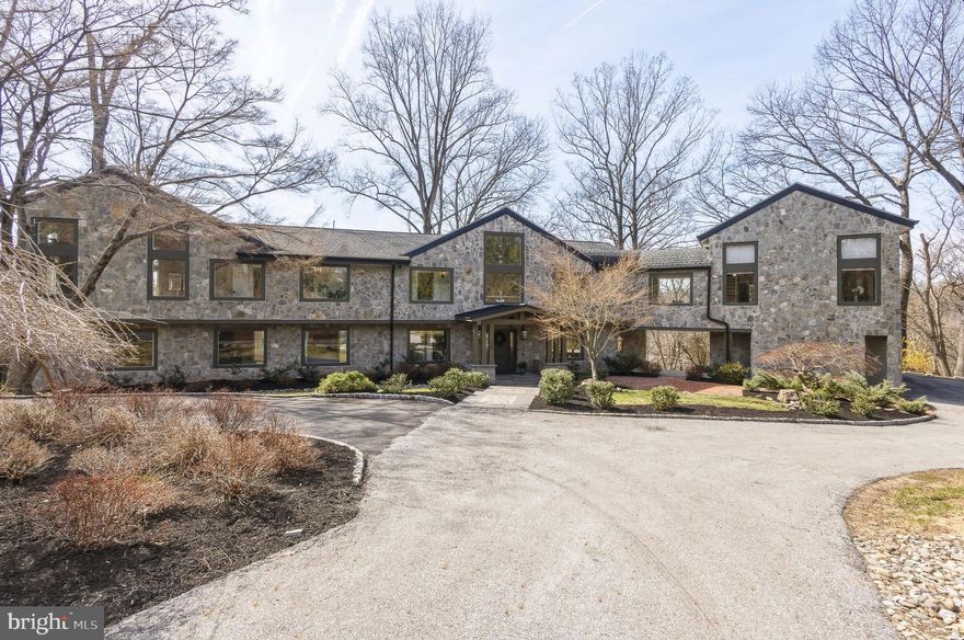 Stunning home on one of Penn Valley’s most desirable streets. Extensively renovated in 2019, this exceptional custom home offers 6 bedrooms, 7 full baths, and 1 half bath across more than 8,000 square feet of beautifully designed living space. Privately situated on a 2.78-acre interior lot, the home showcases a sophisticated transitional style, oversized windows, and wide-plank hardwood floors that have just been newly refinished.

A striking entry opens to an expansive, light-filled layout where the grand kitchen and dining area flow seamlessly into a breathtaking two-story great room. Featuring exposed beams, a dramatic floor-to-ceiling stone gas fireplace, and walls of glass, this space leads to a serene rear deck overlooking the landscaped grounds and resort-style pool.

The chef’s kitchen is both elegant and functional, complete with a massive quartz waterfall island, custom wood cabinetry, dual sinks, two dishwashers, and high-end stainless steel appliances. The main level also includes two bedroom suites with private baths, a dedicated office, and a powder room.

Upstairs, two luxurious primary suites provide exceptional comfort and flexibility. The main suite boasts vaulted ceilings, custom built-ins, a spacious walk-in closet, and a spa-like bath with dual vanities, soaking tub, and oversized shower. The second suite features vaulted ceilings, a lofted sitting area or office, walk-in closet, and a beautifully appointed bath with dual vanities and a large walk-in shower. This level also includes an additional bedroom suite, a full laundry room, and an expansive theater room with its own full bath.

The finished walk-out lower level offers incredible versatility, ideal for an au pair or in-law suite. With a private entrance, it includes a bedroom with walk-in closet, full bath, second laundry room, and a large recreation or playroom.

The lush, private grounds are perfect for relaxing or entertaining—whether enjoying the pool, dining al fresco, or unwinding on the patio. Complete with a 3-car garage equipped with an EV charger, this home offers both luxury and convenience. Located in the award-winning Lower Merion School District and just minutes from Narberth, Gladwyne Village, and major commuting routes to Center City, this move-in-ready residence is a rare opportunity not to be missed.