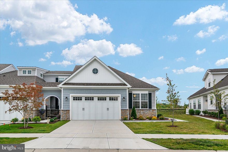 Take advantage of this rare opportunity to move into Bay Bridge Cove, a beautiful 55+ community. This luxury villa-style home is move-in ready and located just steps away from an amenity-filled clubhouse! The spacious open floor plan features 2 bedrooms, 2 bathrooms, a 2 car garage, and much more! Beautiful flooring, vaulted ceilings, a shiplap feature wall, custom blinds, and a cozy gas fireplace are just a few touches you’ll notice as soon as you walk through the front door. In the kitchen you’ll find quartz countertops, a timeless back-splash, soft close cabinets, stainless steel appliances, and a gas stove- making it the perfect space to entertain! Head outside to continue the fun on the paved patio! The primary bedroom features a spacious walk-in closet and a large primary bathroom, finished with double sinks, a built-in shower bench, and a glass shower door. Down the hall, you’re greeted with an additional generously-sized bedroom and a full bathroom. The Community’s HOA takes care of your yard maintenance and snow removal, allowing you more time to enjoy your new home! Bay Bridge Cove’s amenities include a pool, a clubhouse, a billiard room, a fitness center, tennis courts, a community garden, and so much more! If you’re looking for the perfect place to call home, you’ve found it!