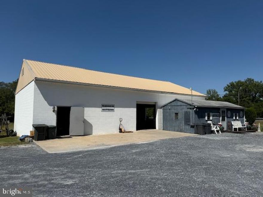 2,600 SF Warehouse Building for Lease - great corner location!  Open space with one 9x9' overhead Door, one Dock Door & ample parking.  Lease includes land immediately surrounding the building (approx. 1/2 acre).  Porta Potty available.  Heat & Electric paid by tenant.  Lease is for white block building only - Blue Mobile Office building to be available in 3-6 months at additional cost.