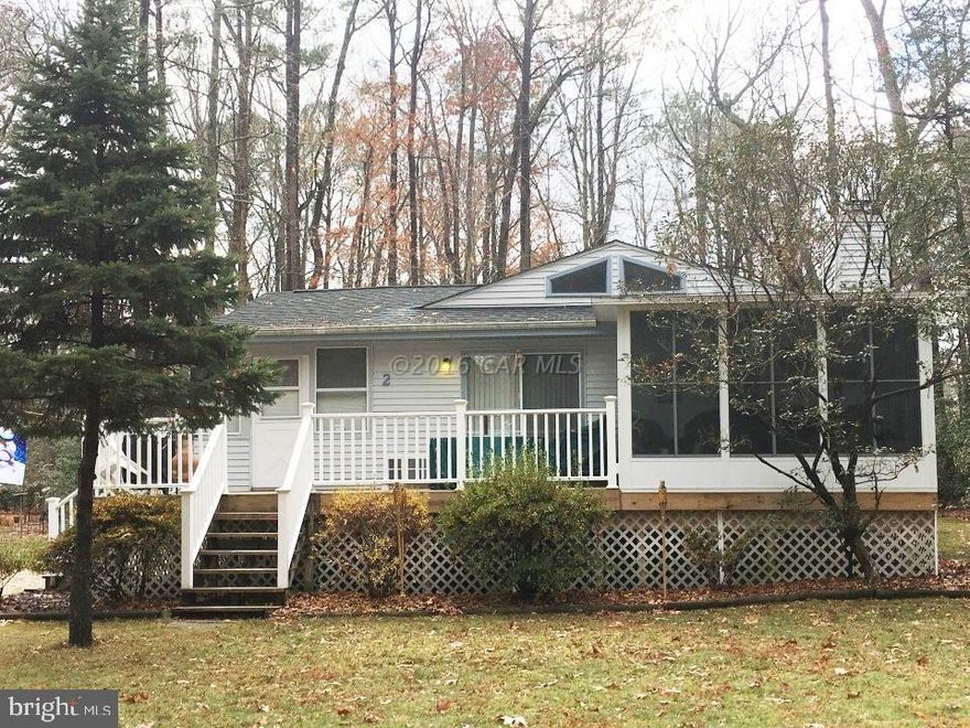 Your Place at the Beach! Enjoy all seasons. Lots of room to park boats, bikes, cars on huge corner lot. Enjoy the view from the 3 Season (Glass) Porch or on the front deck. Cozy Great room with Cathedral ceiling has a brick wall wood Fireplace and Built Ins. There is even an extra enclosed porch used as a sitting room. Roof is 3 yrs old and 3 Season Room is 2 yrs. Large Shed holds all your beach toys and yard tools.